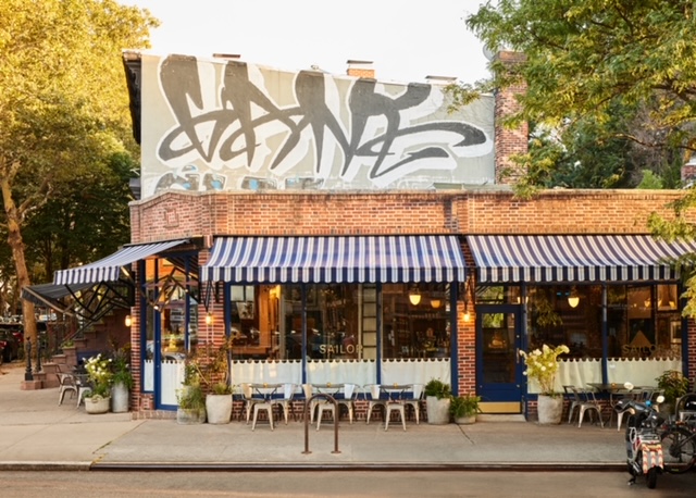 a building with graffiti on the side of a road
