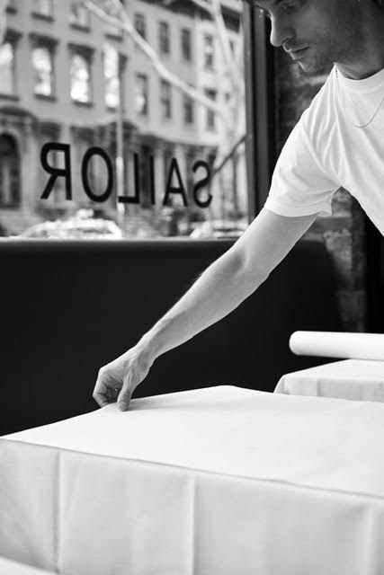 a man standing in front of a table