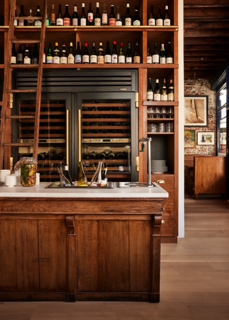 a kitchen with a book shelf