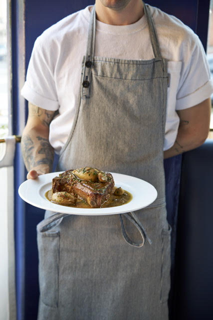 a man sitting in front of a plate of food