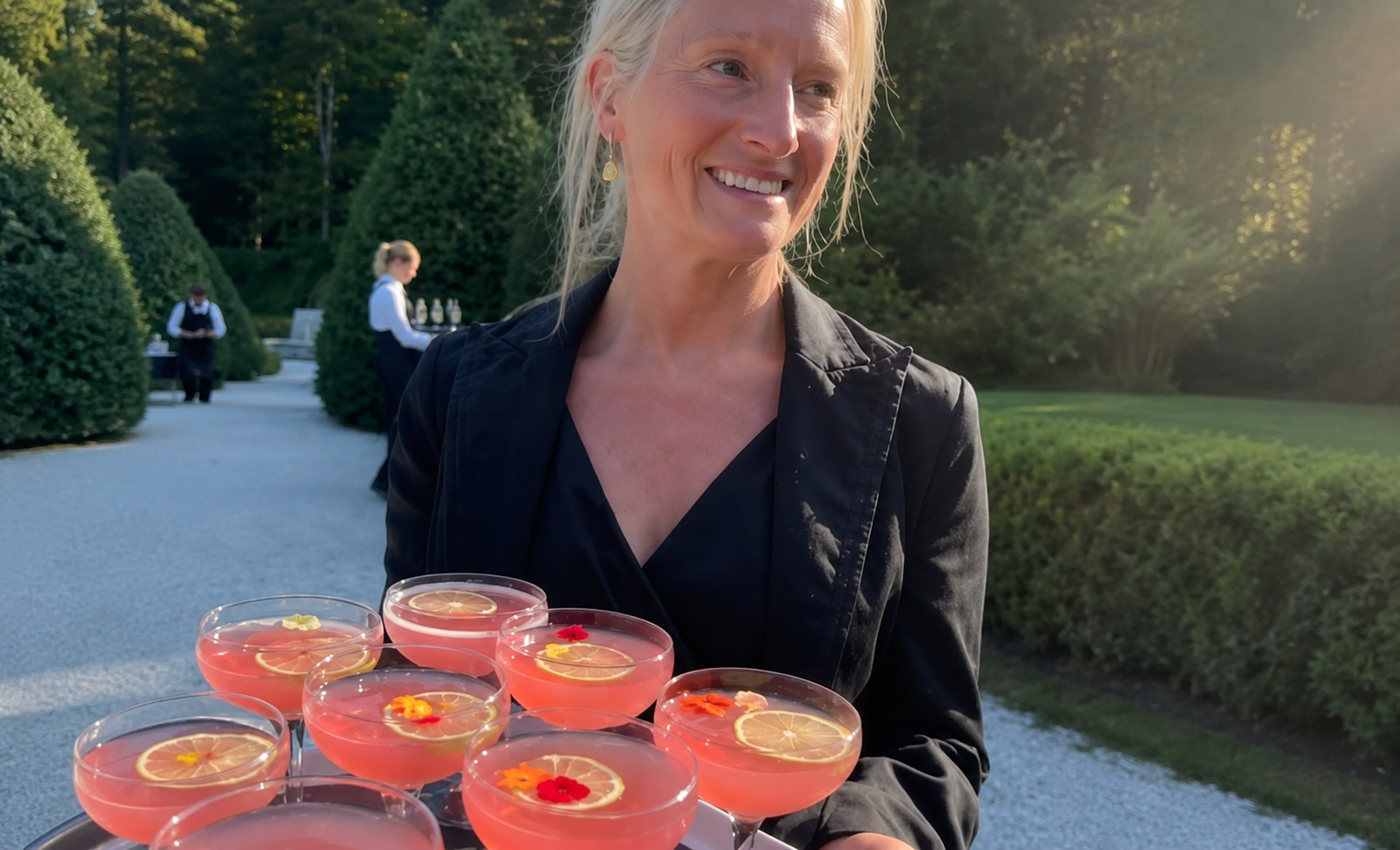 a woman holding a tray of drinks