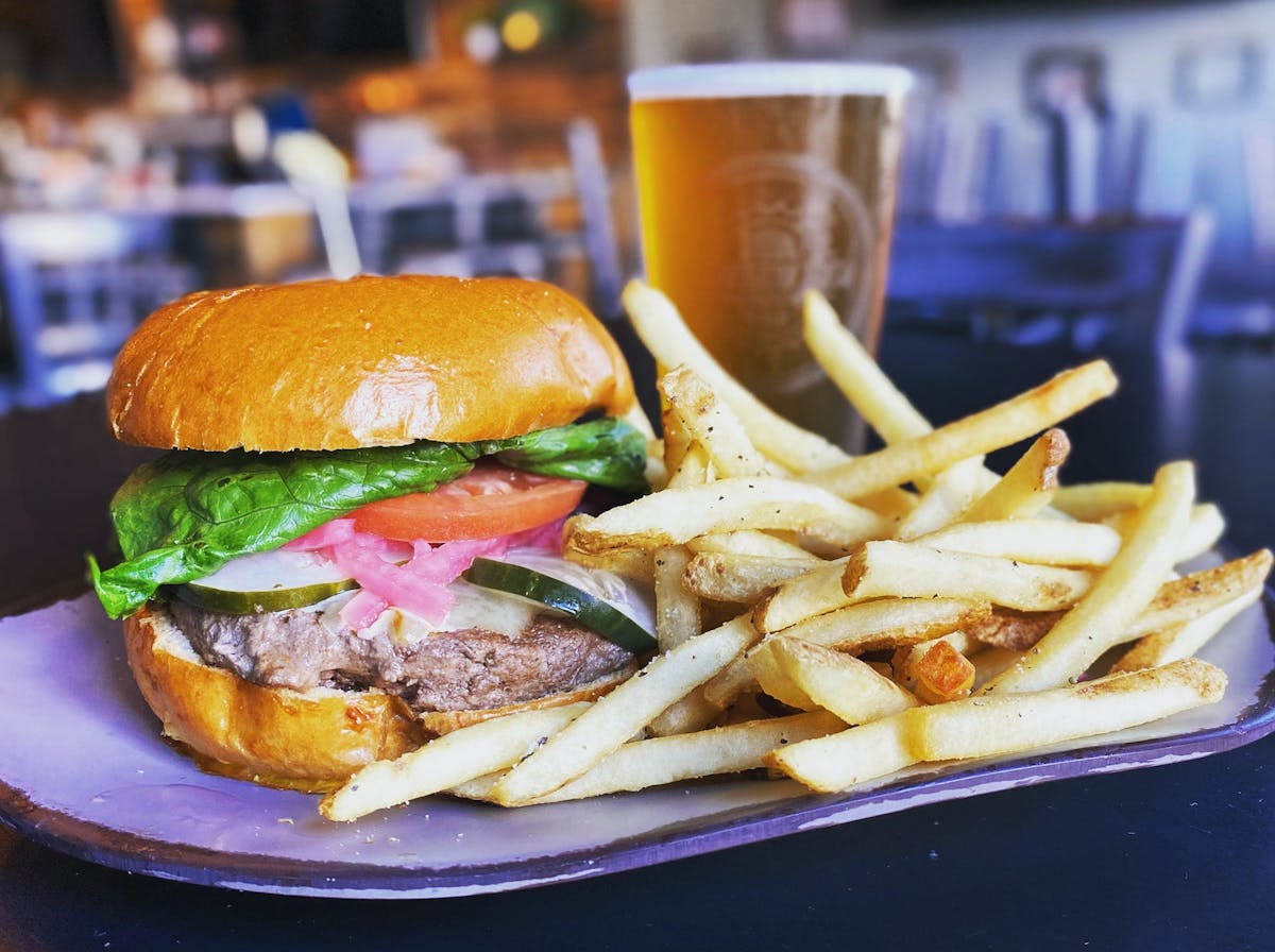 a close up of a sandwich and fries on a plate