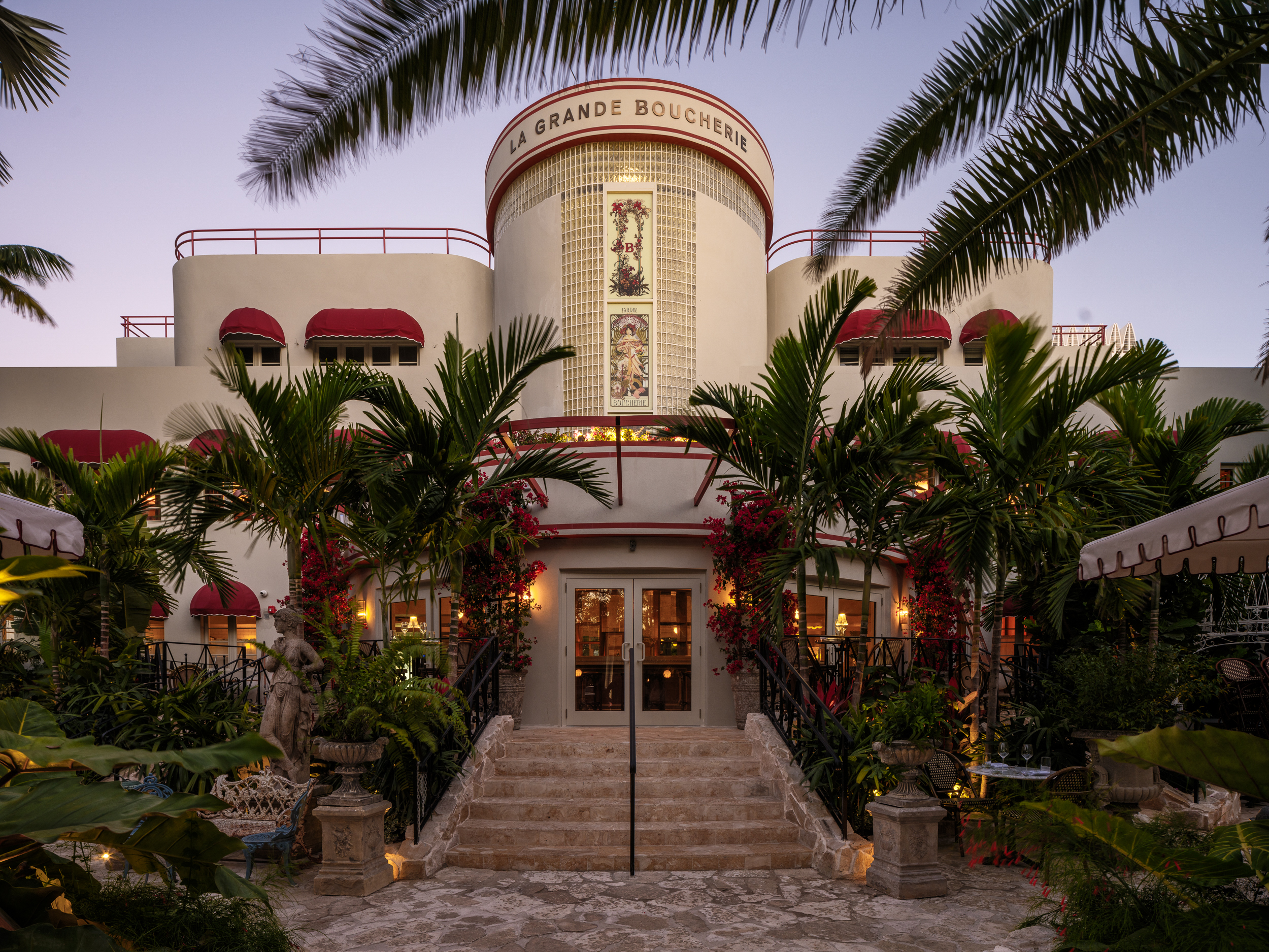 a palm tree in front of a building