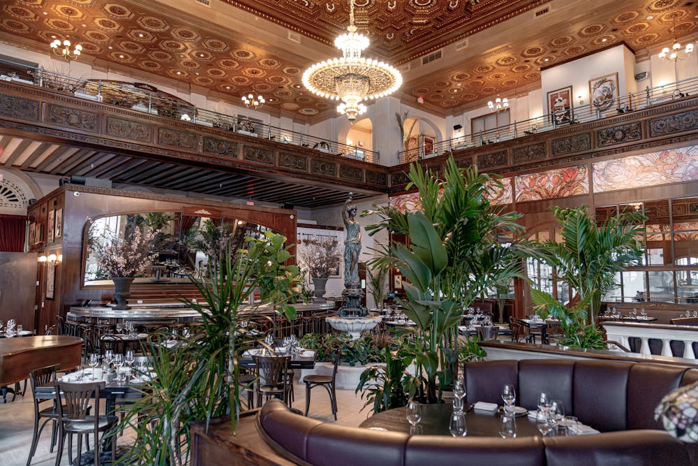 a living room filled with furniture and vase of flowers on a table