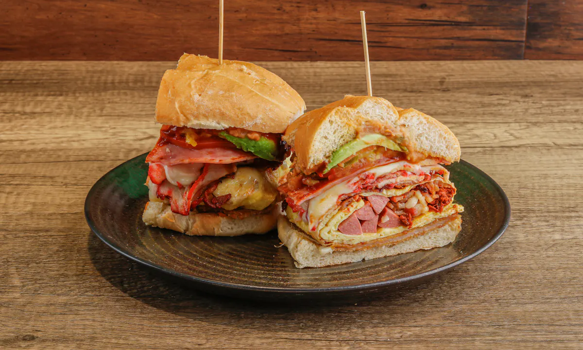 a cut in half sandwich sitting on top of a wooden table