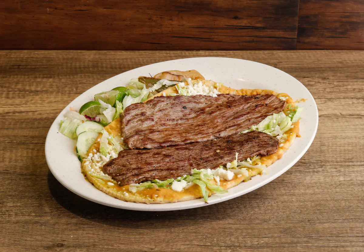 a plate of food sitting on top of a wooden table