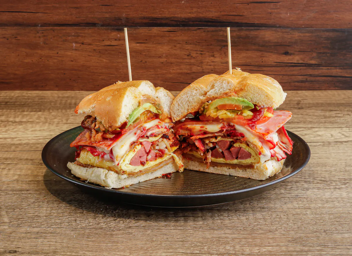 a close up of a sandwich sitting on top of a wooden table
