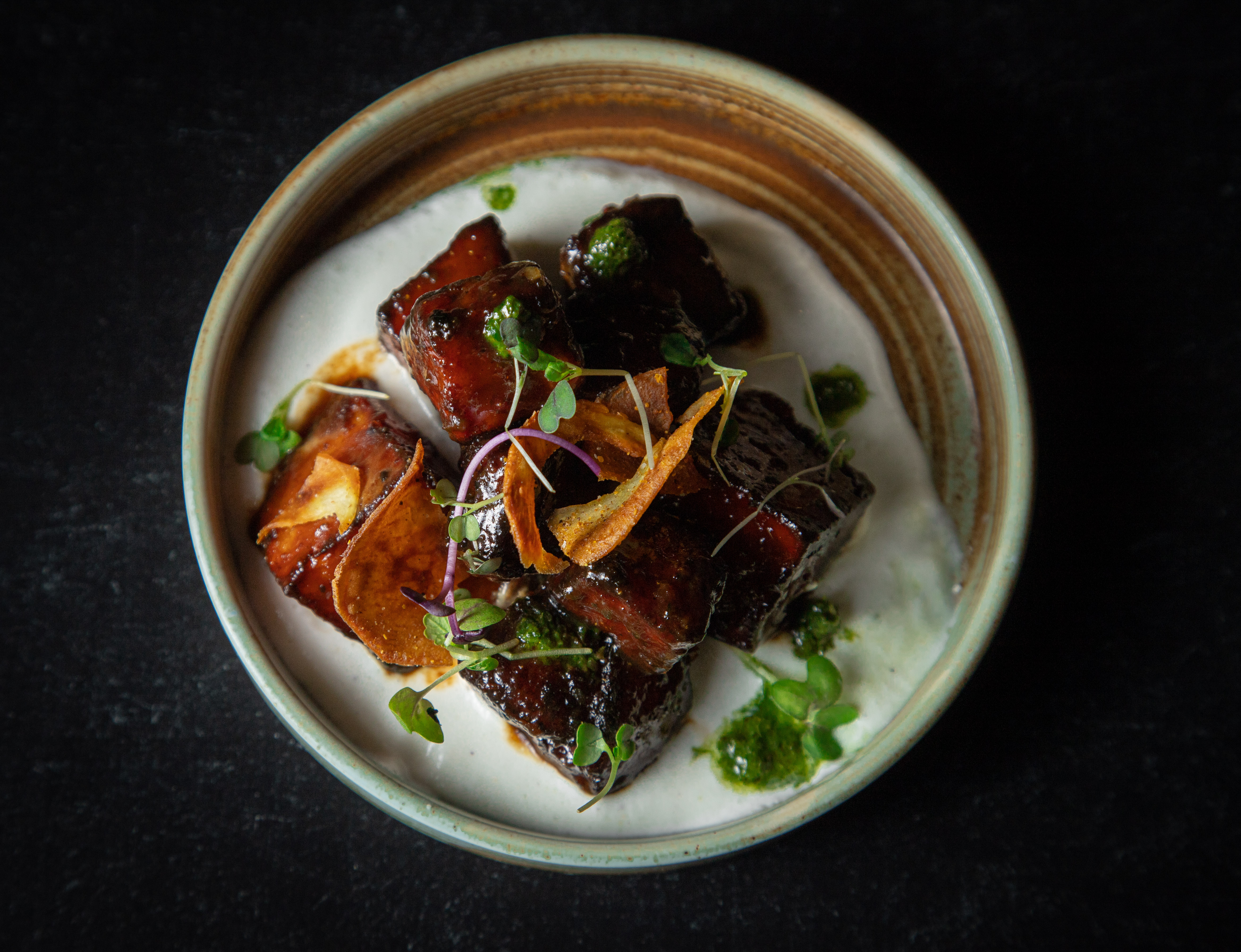 a plate of food on a black surface