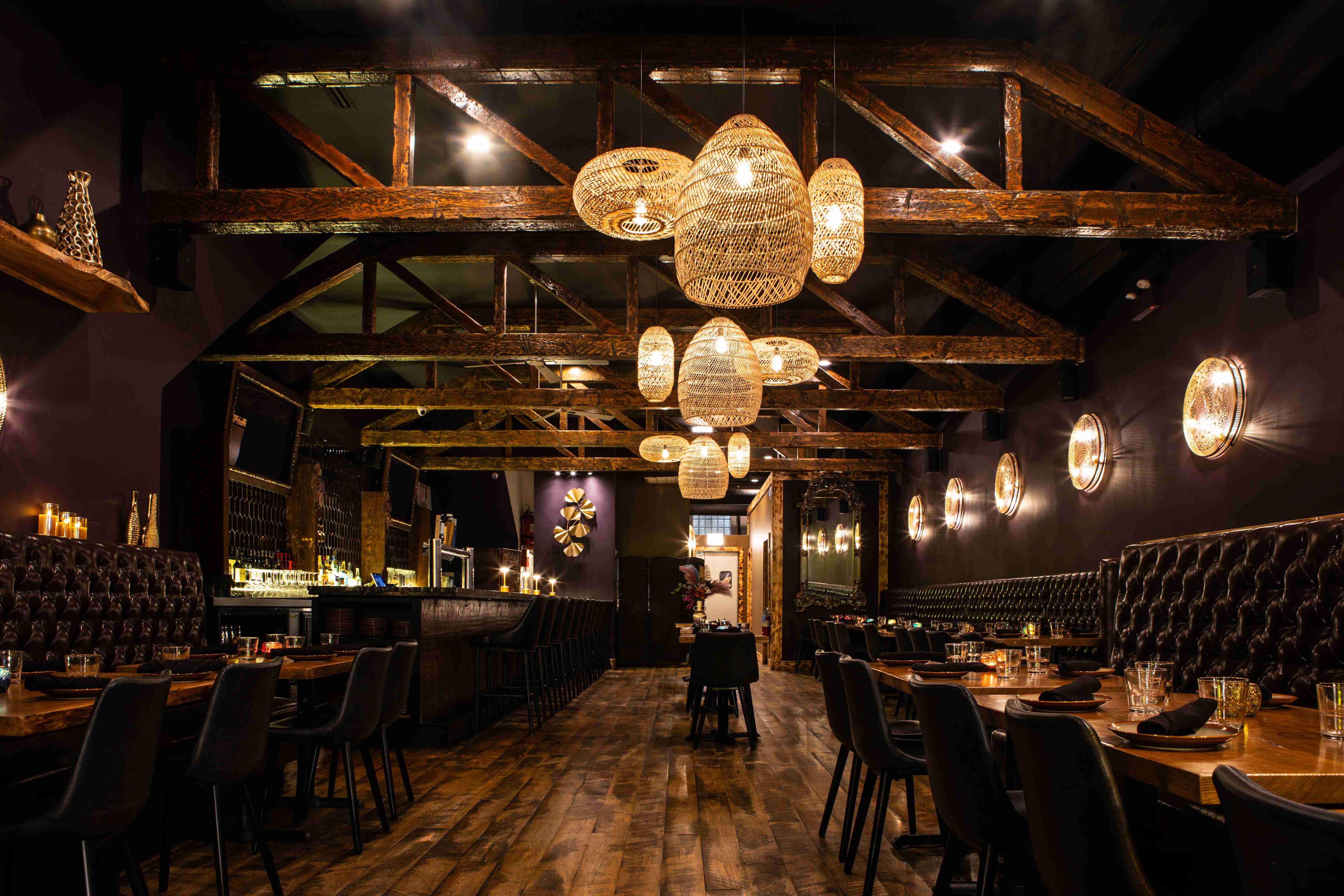 a room with a bar and tables and chairs