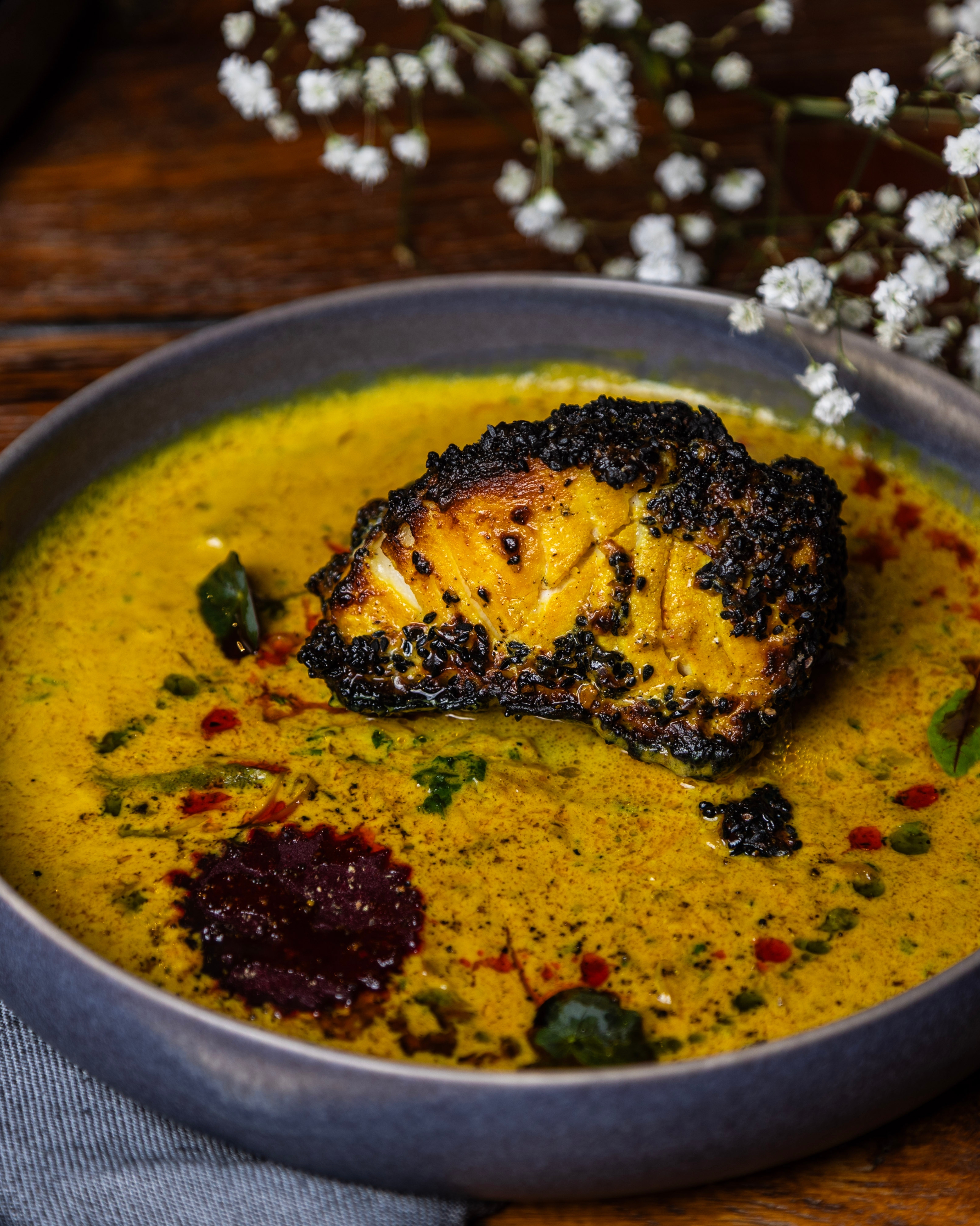 Charcoal-grilled Chilean Sea Bass Molly with Kerala coconut curry at KAMA West Loop