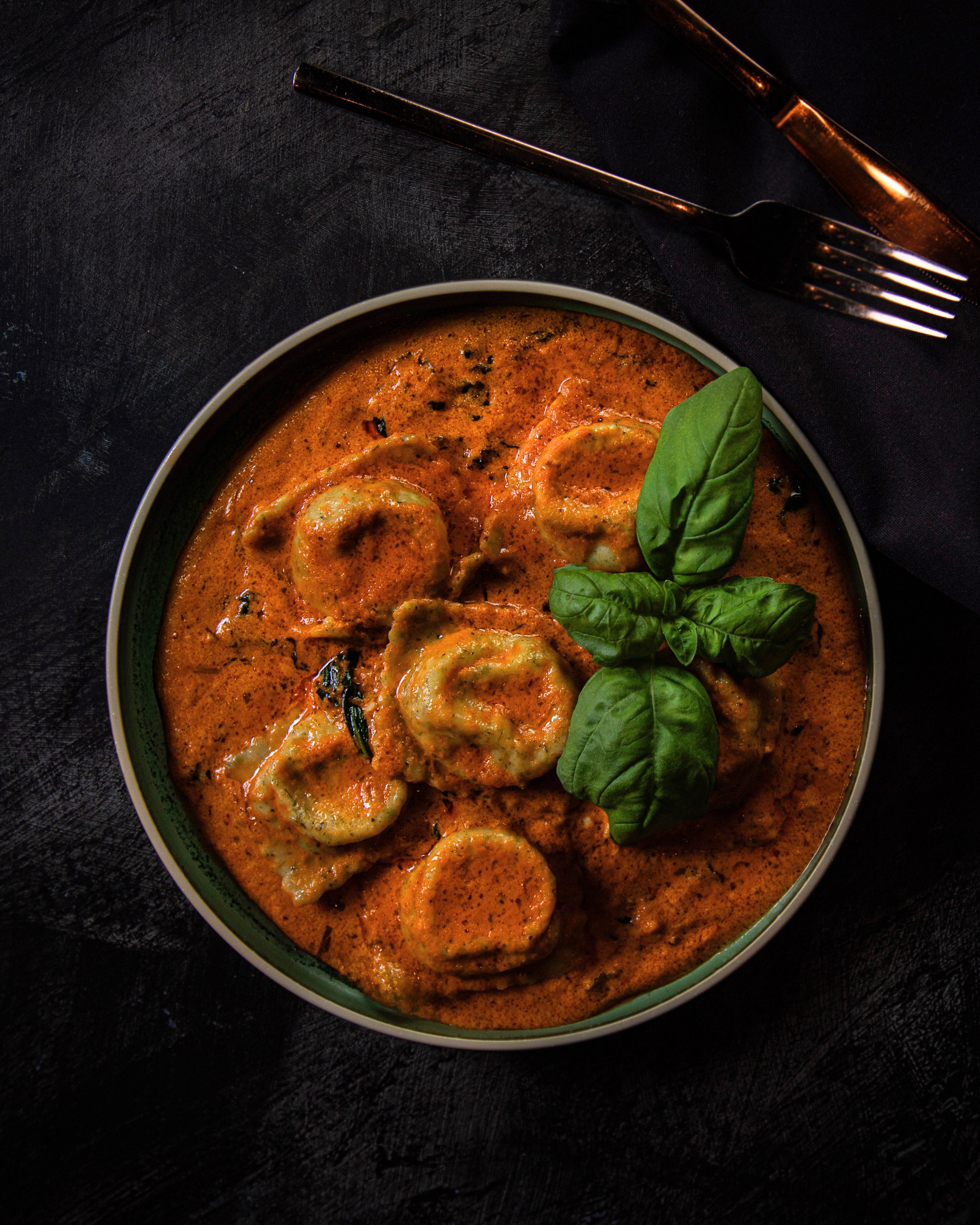 Paneer ravioli plated with fresh basil, a modern Indian signature dish