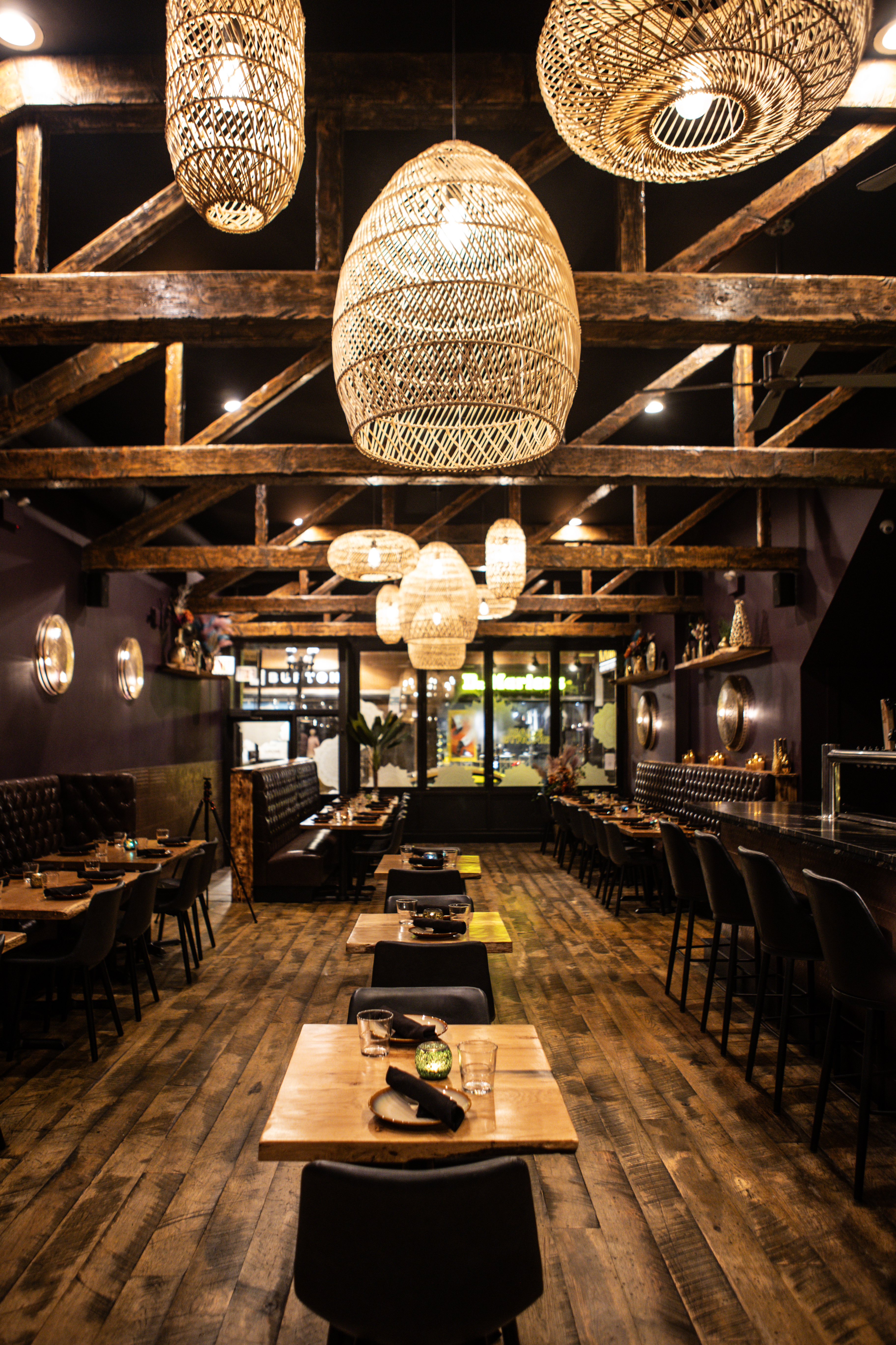 Kama Wicker Park dining room with wood beams, pendant lighting and bar area