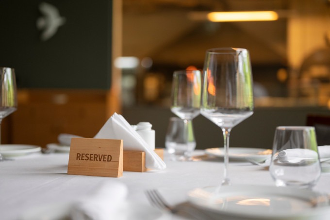 a table with a reserved sign and glasses