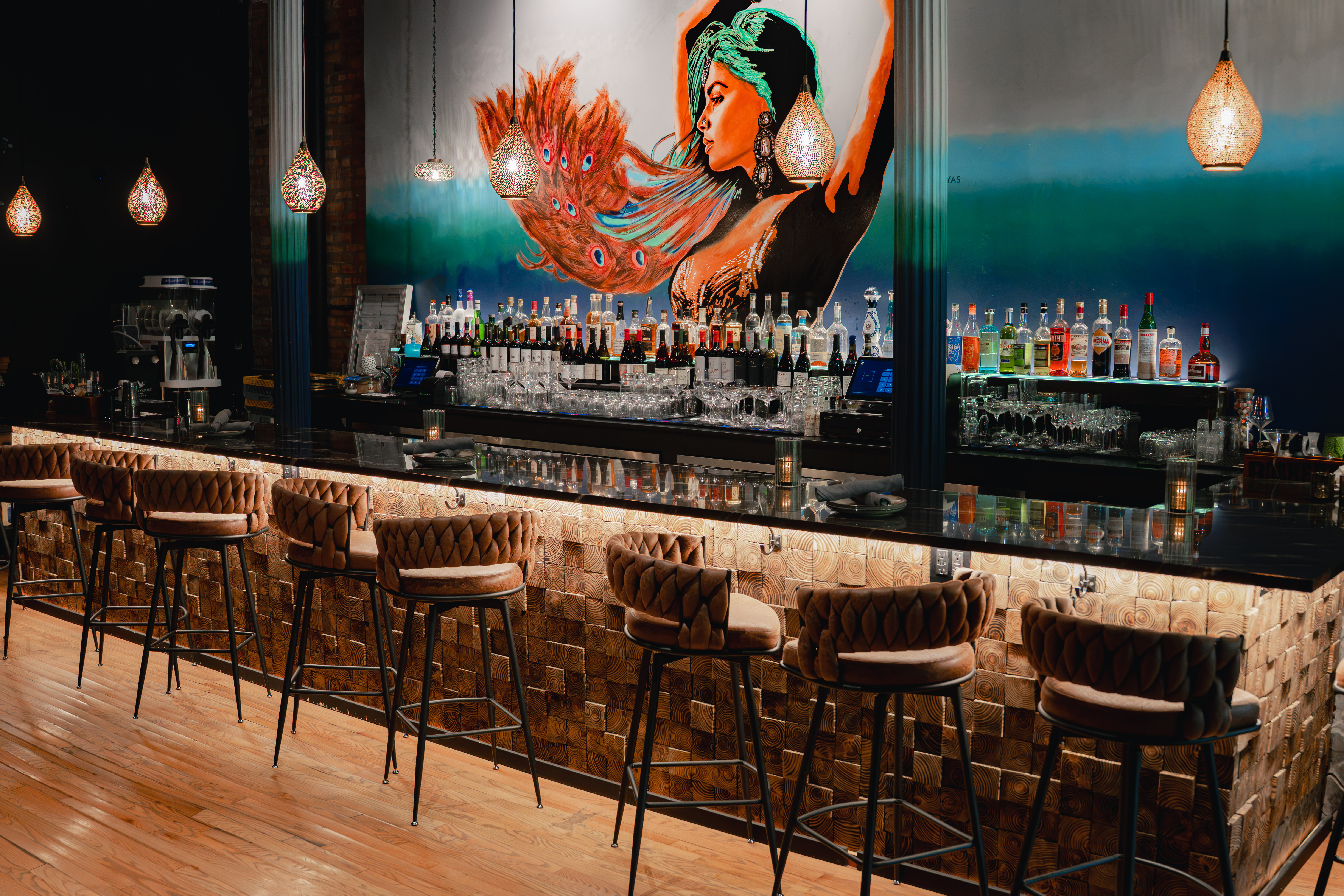 a bar with a painting of a woman on the wall