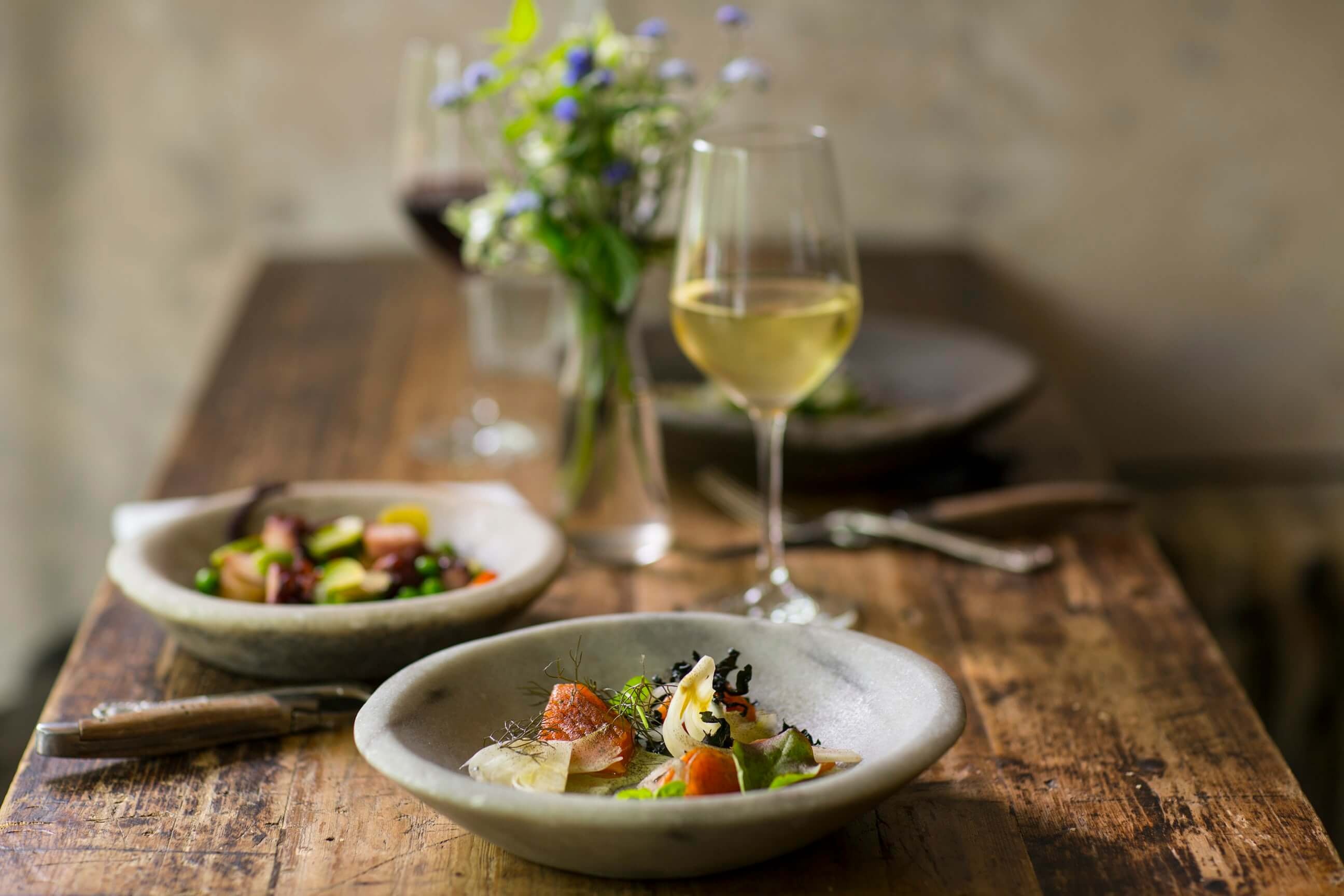 a plate of food and a glass of wine