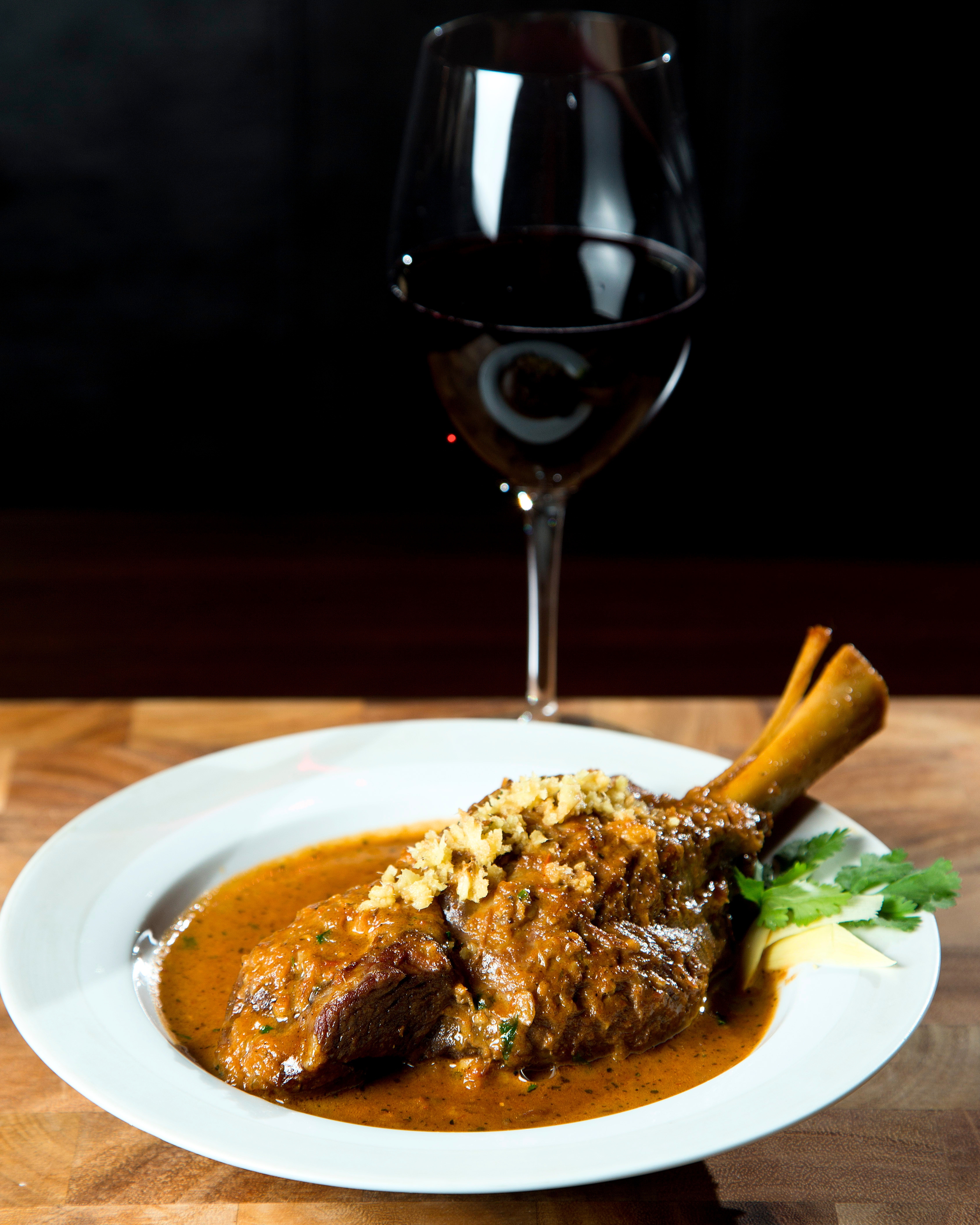 Slow-braised lamb shank plated for a Kama catering event
