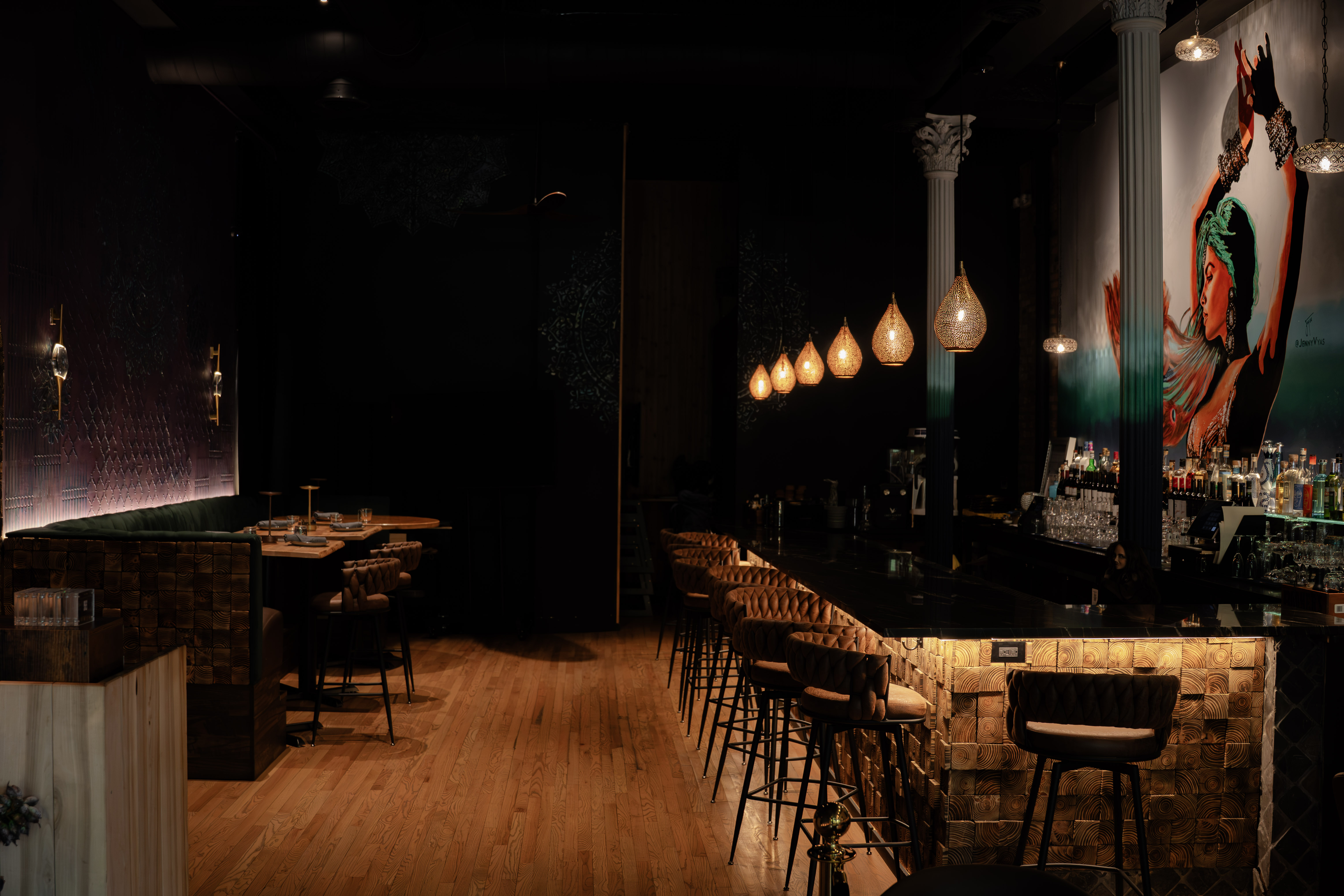 a bar with chairs and lights