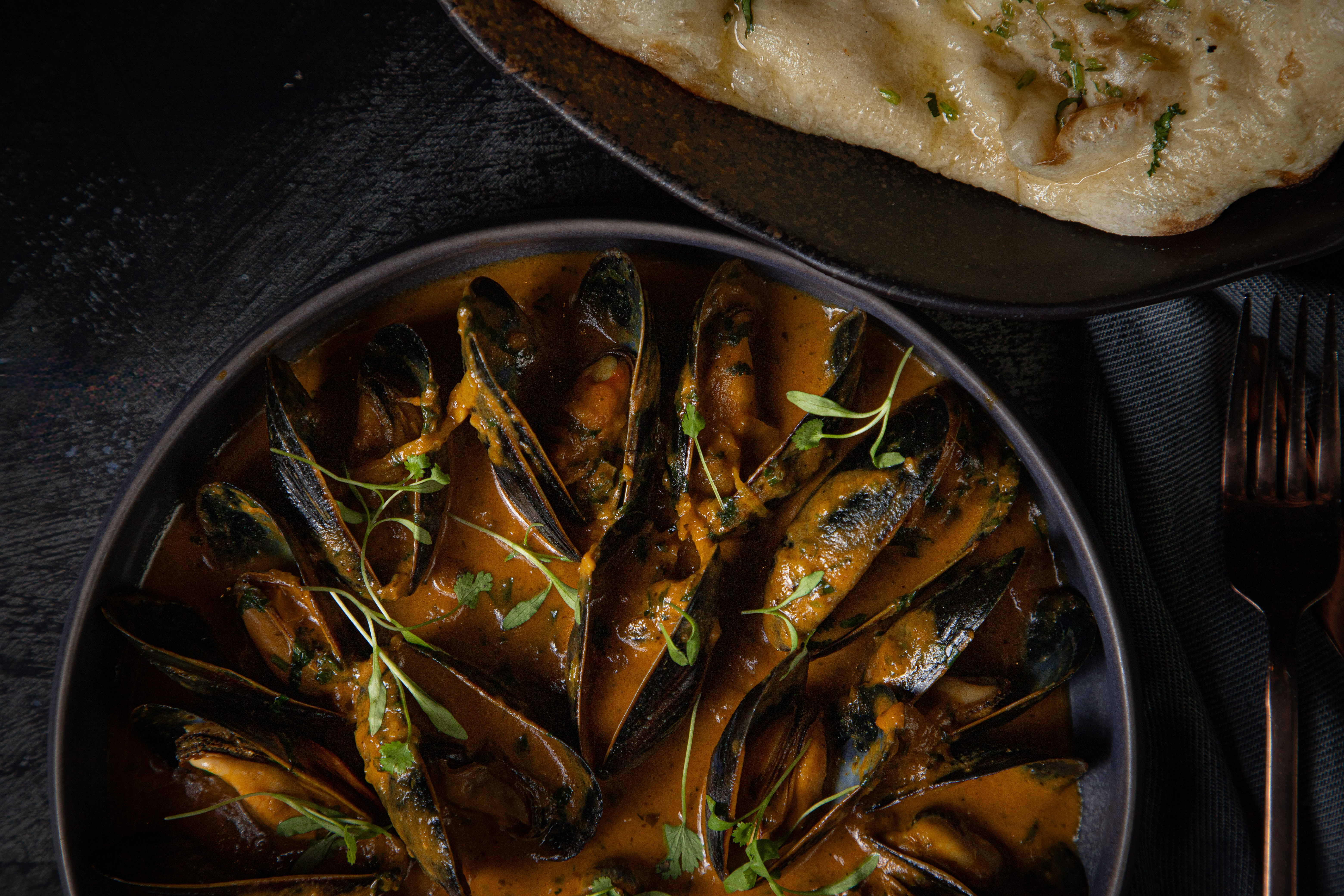 Mussels served with warm naan, a signature Kama catering dish