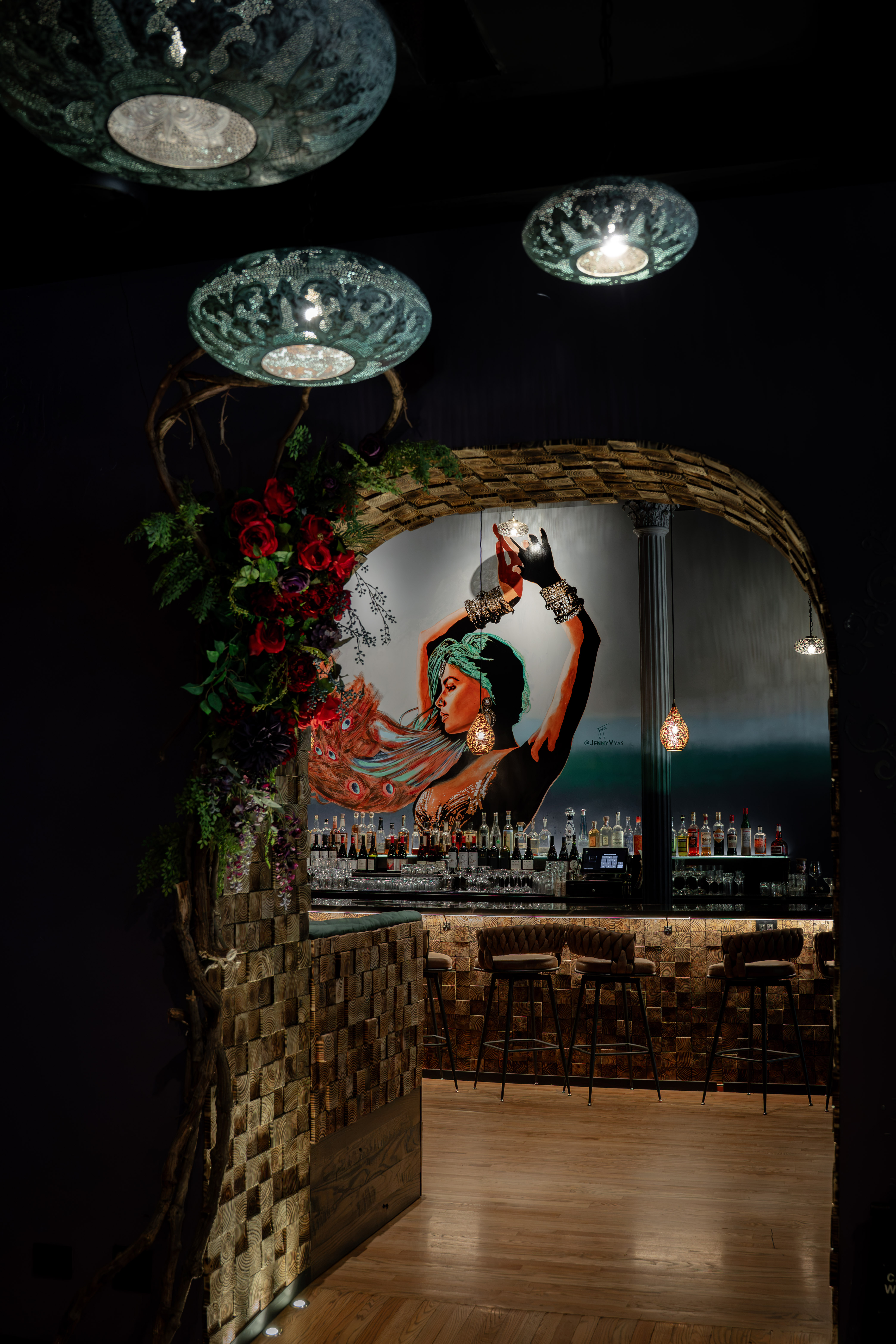 a bar with a painting of a woman in a scarf