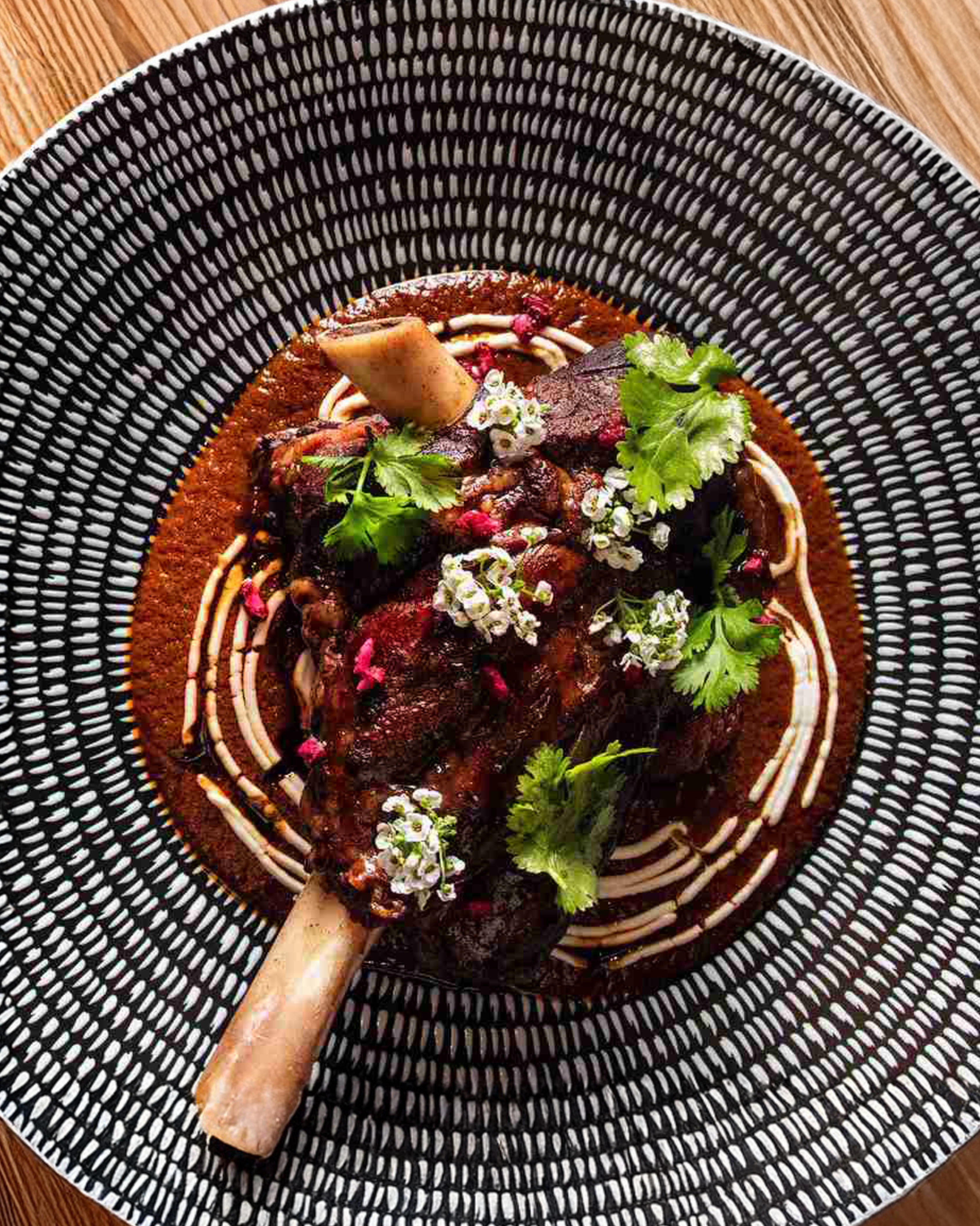 a plate of food on a wood table