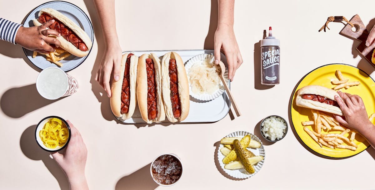 a person holding a hot dog