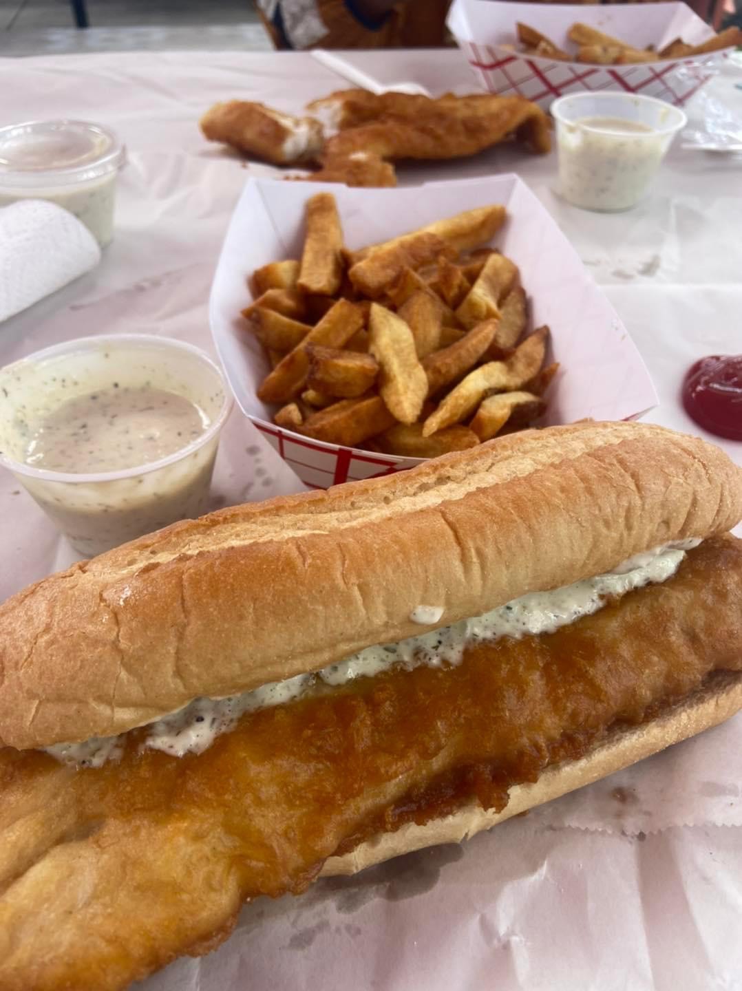 a close up of a sandwich and fries on a table