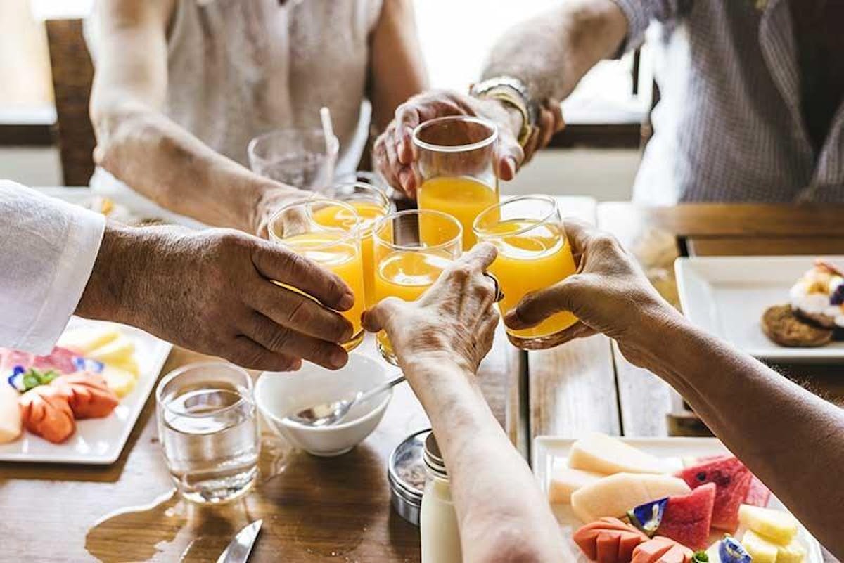 a group of people are drinking from a cup
