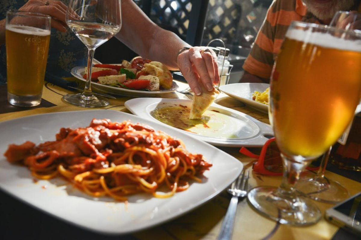 a person sitting at a table with a plate of food