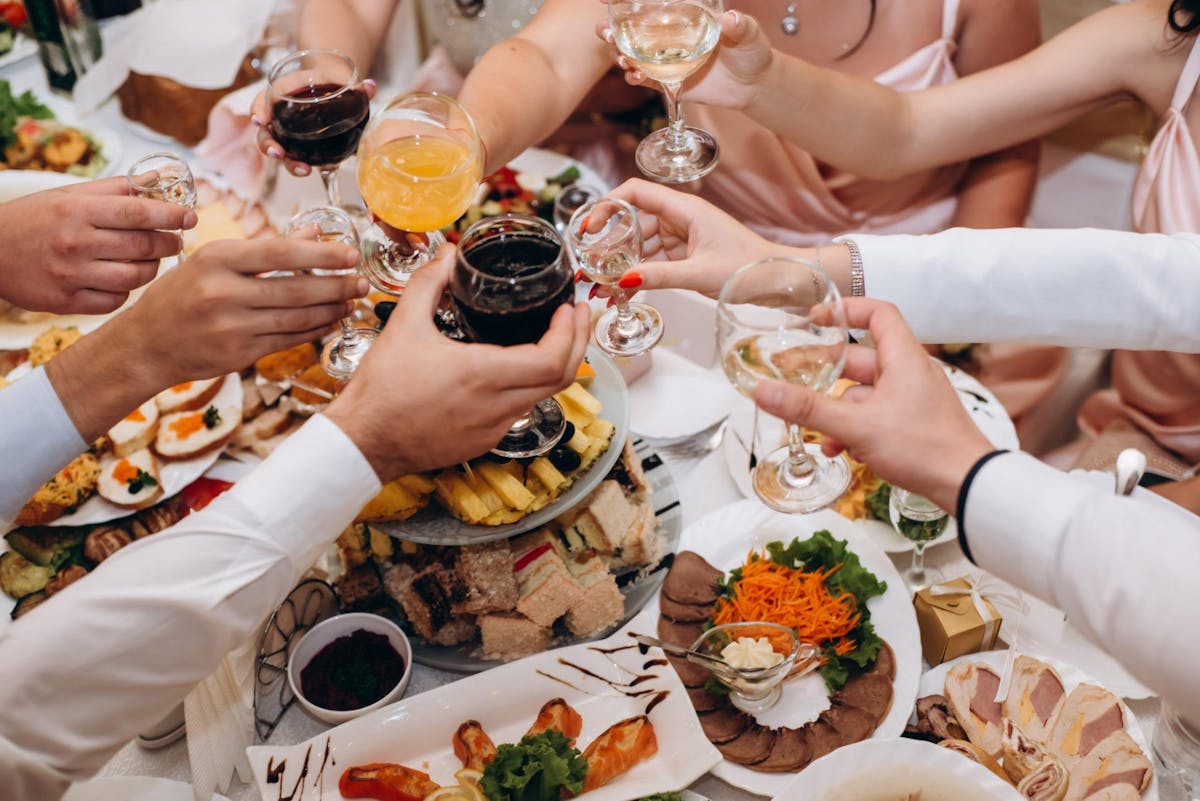 a group of people sitting at a table eating food