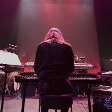 a woman standing in front of a piano