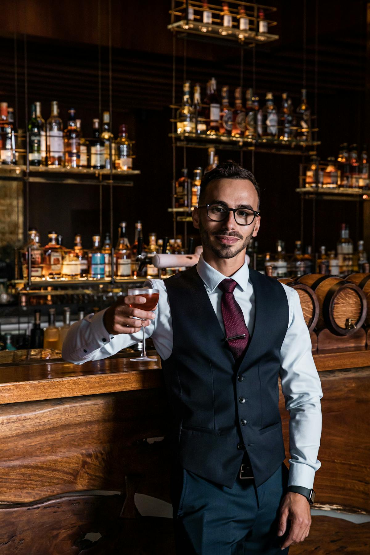a man wearing a suit and tie holding a wine glass