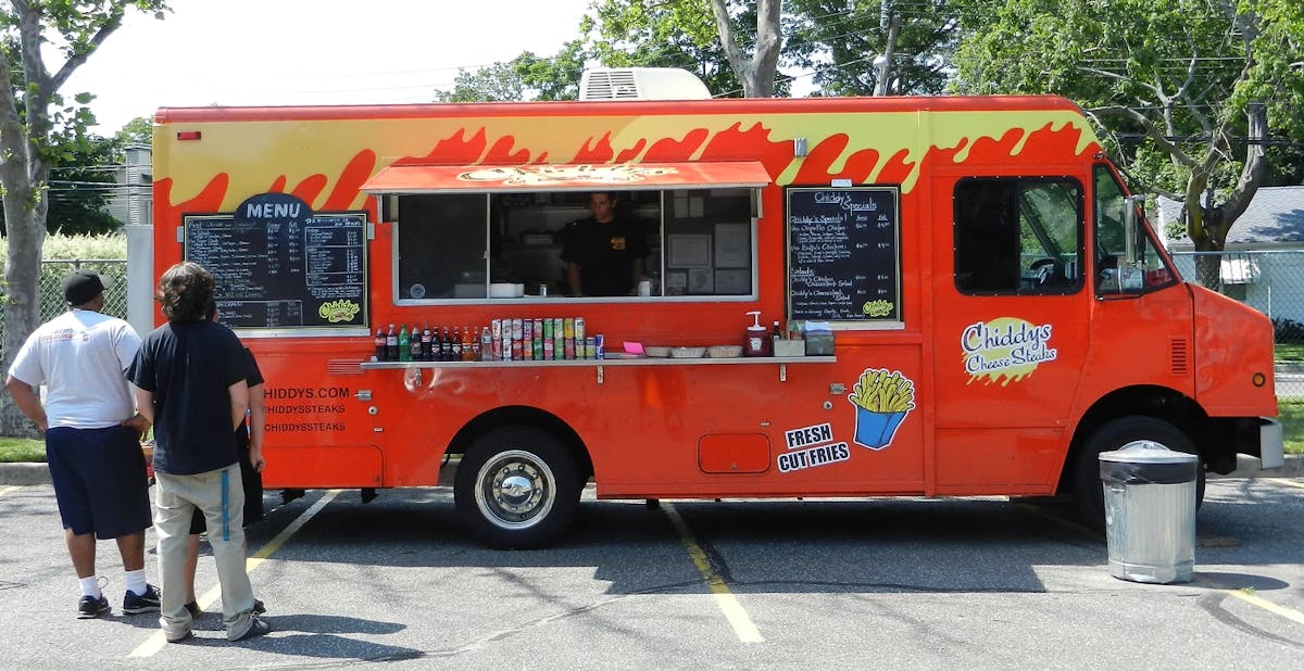 a bus parked in front of a food truck