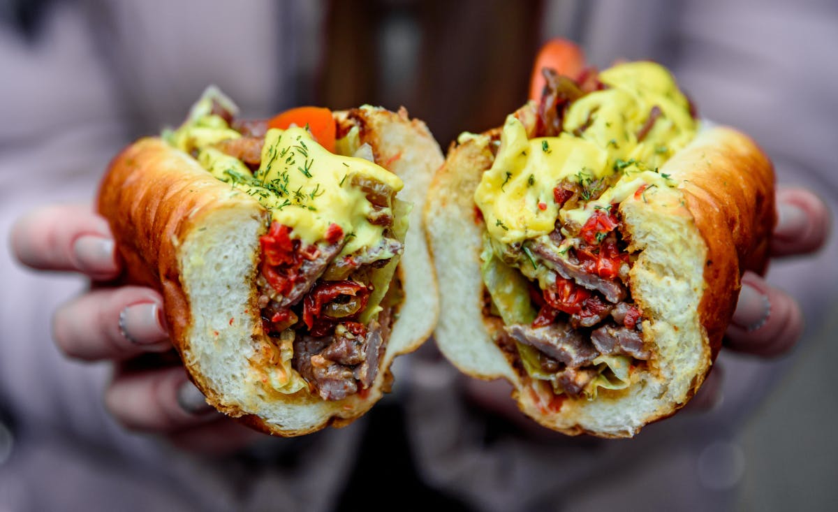 a close up of a hand holding a sandwich