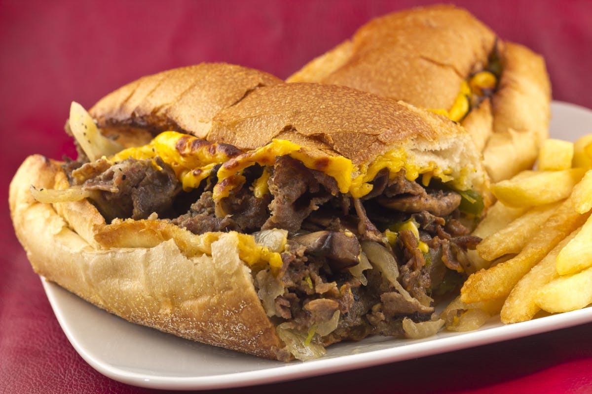 a close up of a sandwich and fries on a plate