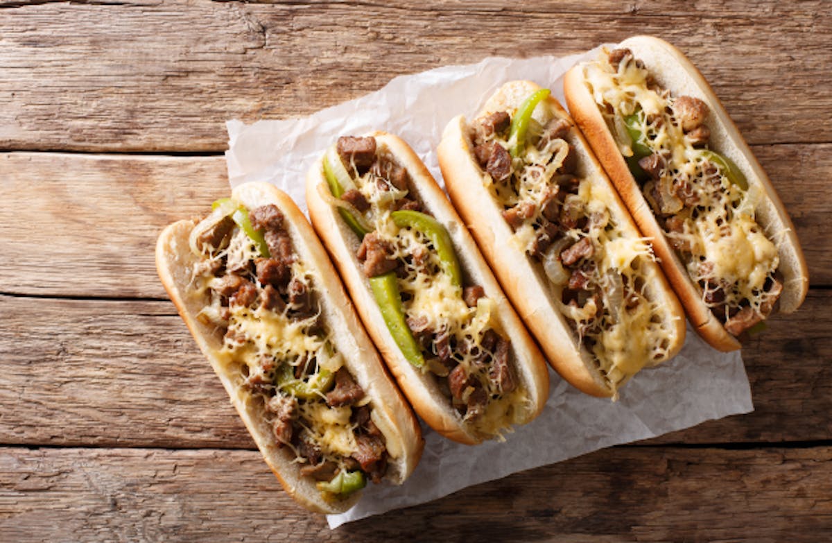 a sandwich sitting on top of a wooden tray holding a hot dog