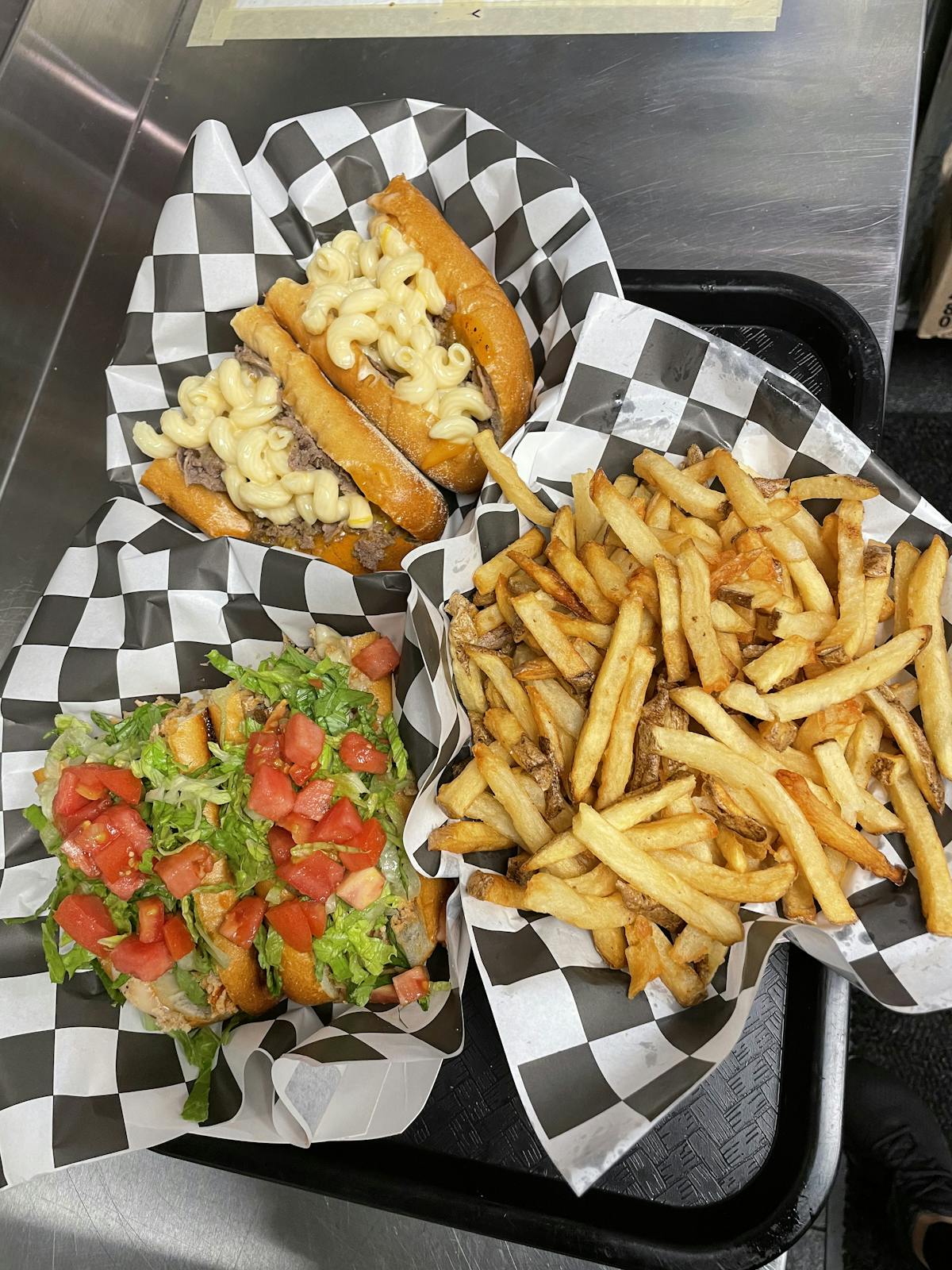 a bunch of hot dogs and french fries on a table