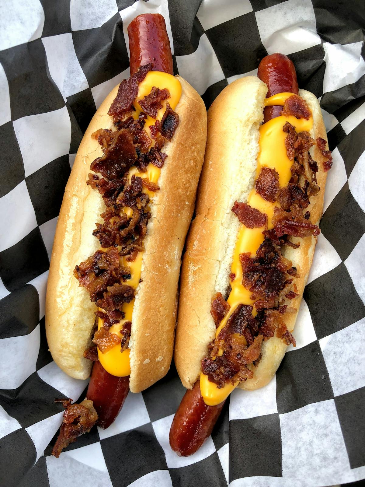 a hot dog on a bun covered in toppings