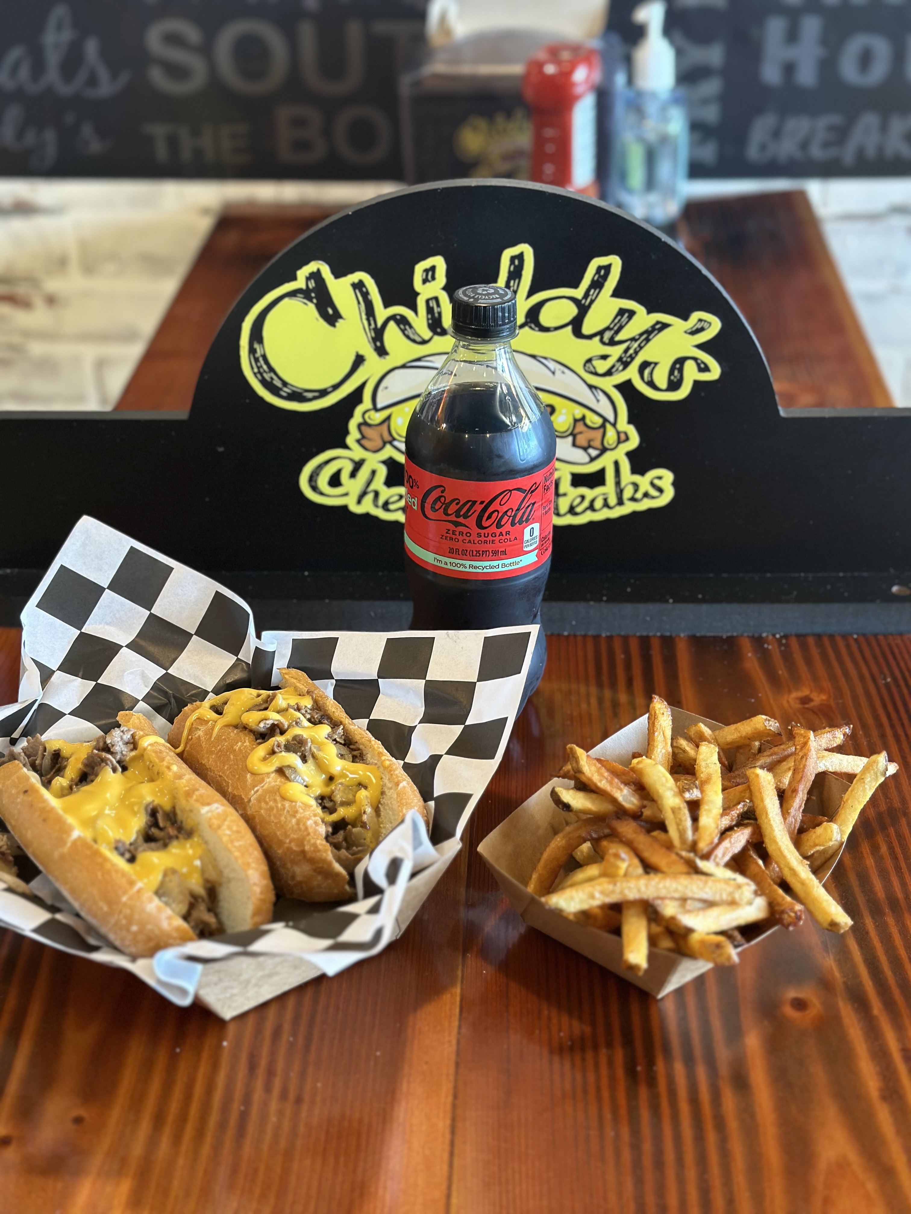 a plate of hot dogs sitting on top of a wooden table