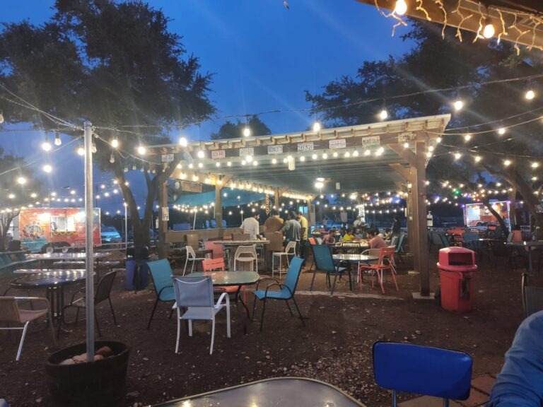 a group of people sitting at a table in front of a building