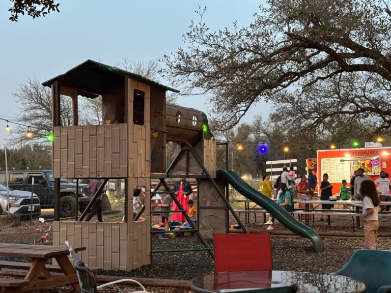a person sitting on a bench in front of a building