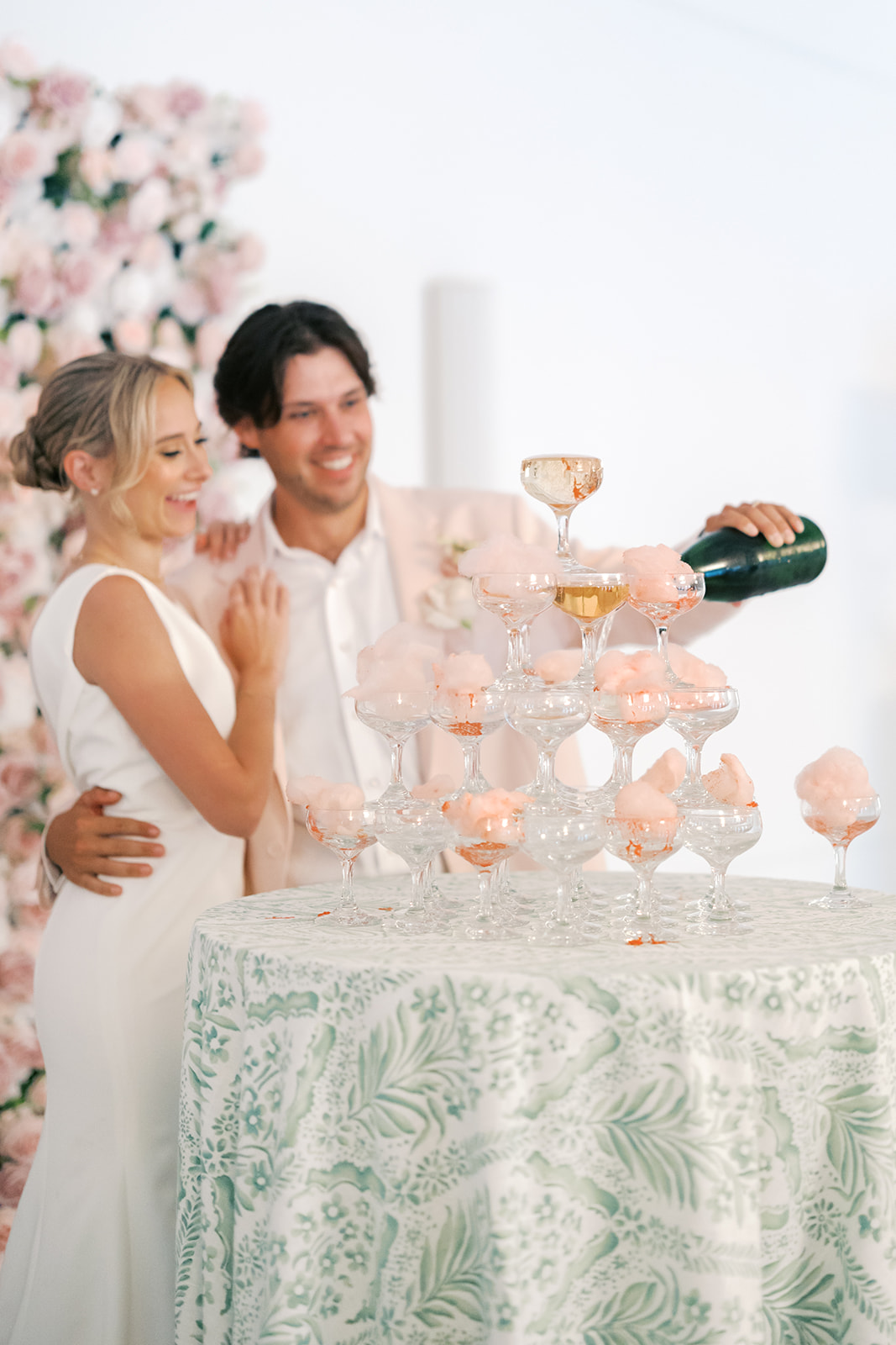 champagne tower with bride and groom
