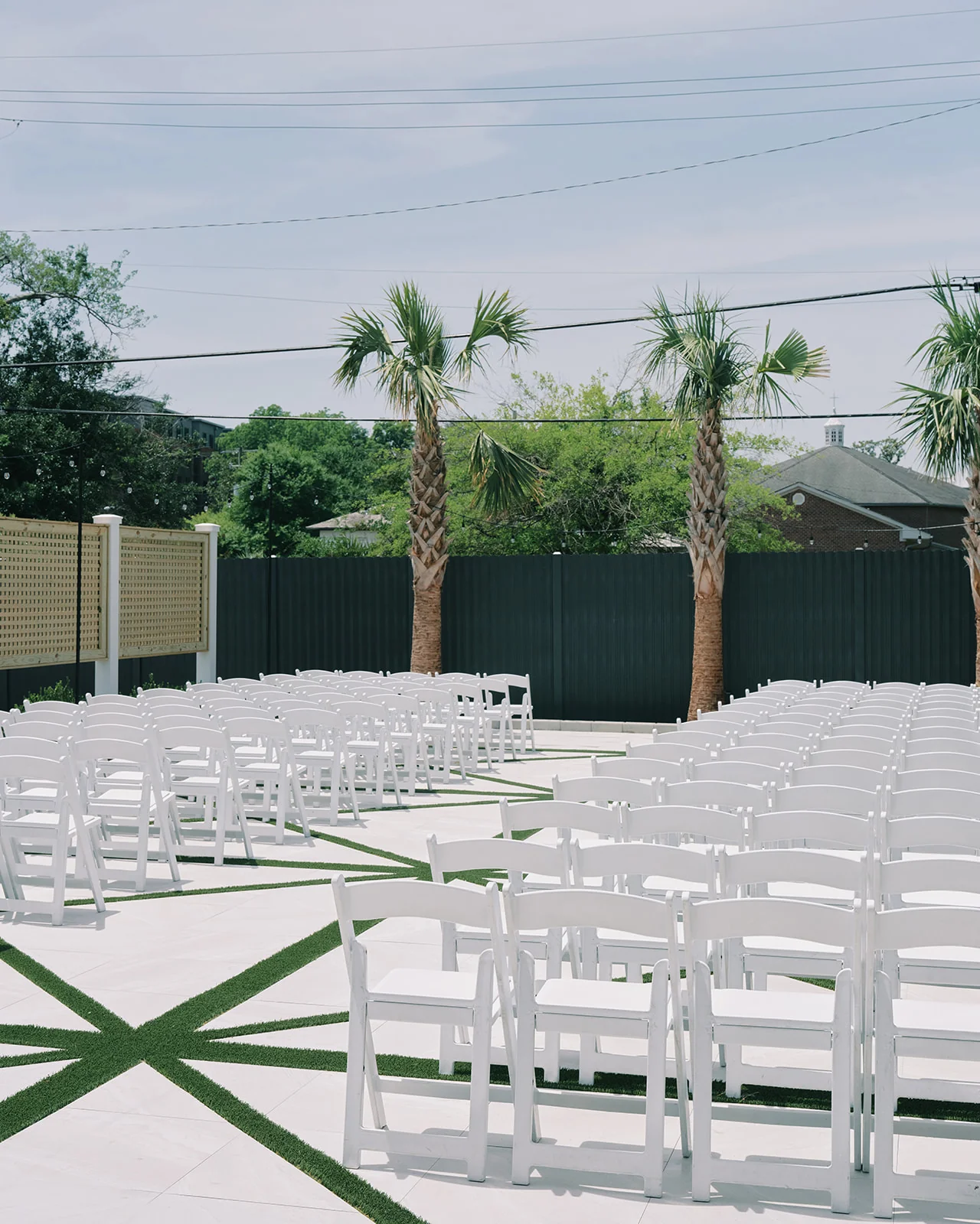 Garden ceremony chairs arranged on the lawn and stone pavers at The Waverly