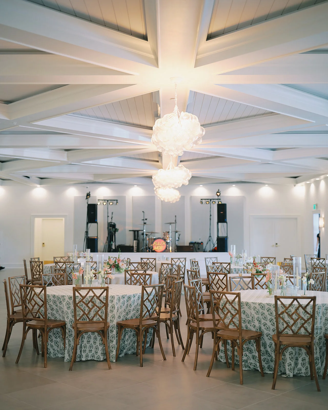 Reception Hall set for a wedding dinner beneath The Waverly's chandeliers