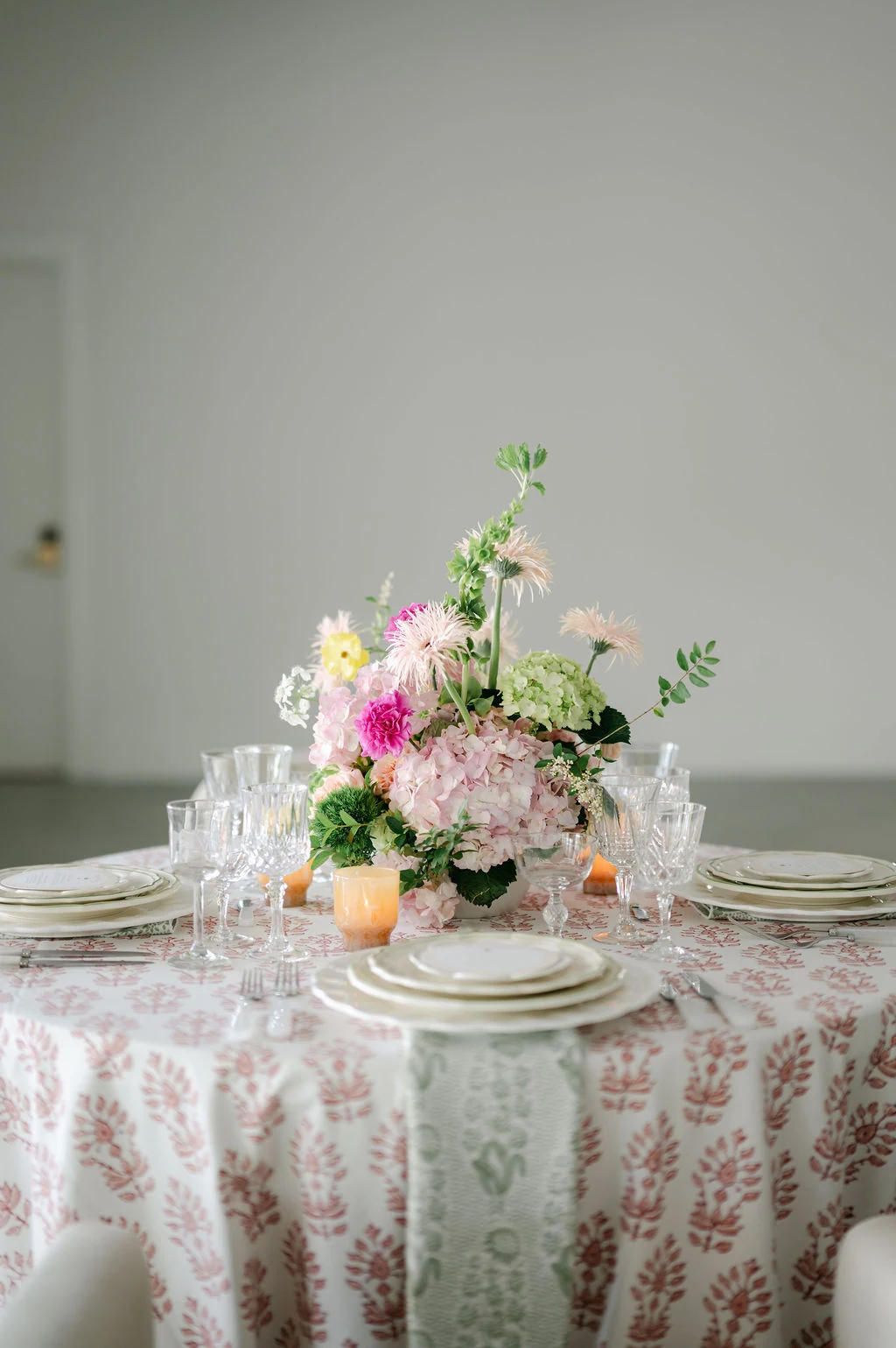 Pink floral centerpiece on a patterned round table