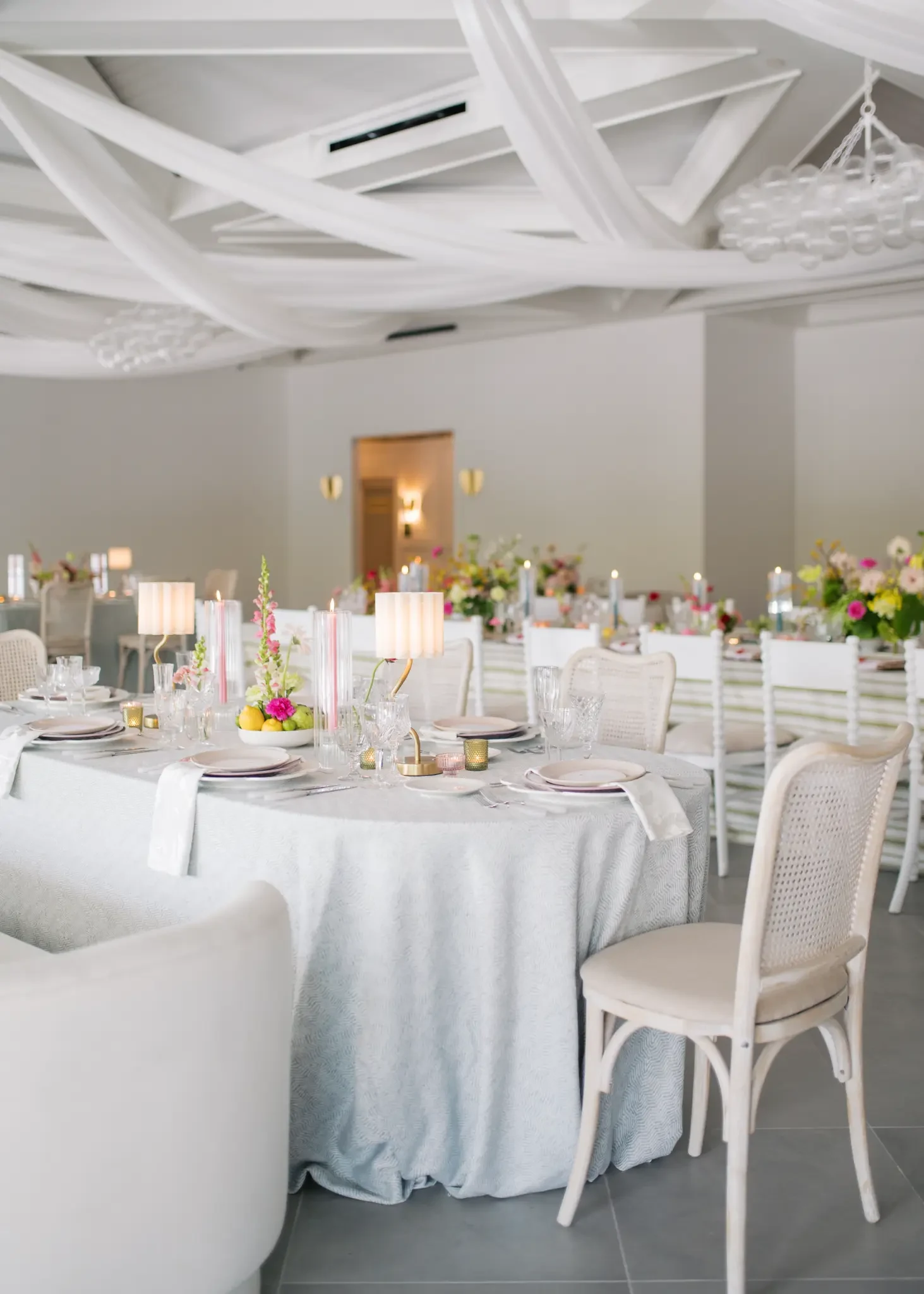 Daytime tables with flowers, candles and chandeliers in The Waverly Reception Hall