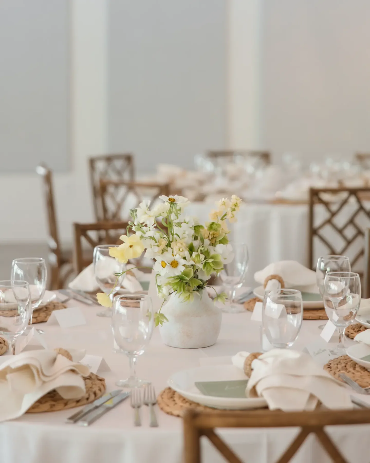 Rehearsal dinner table set with flowers and glassware