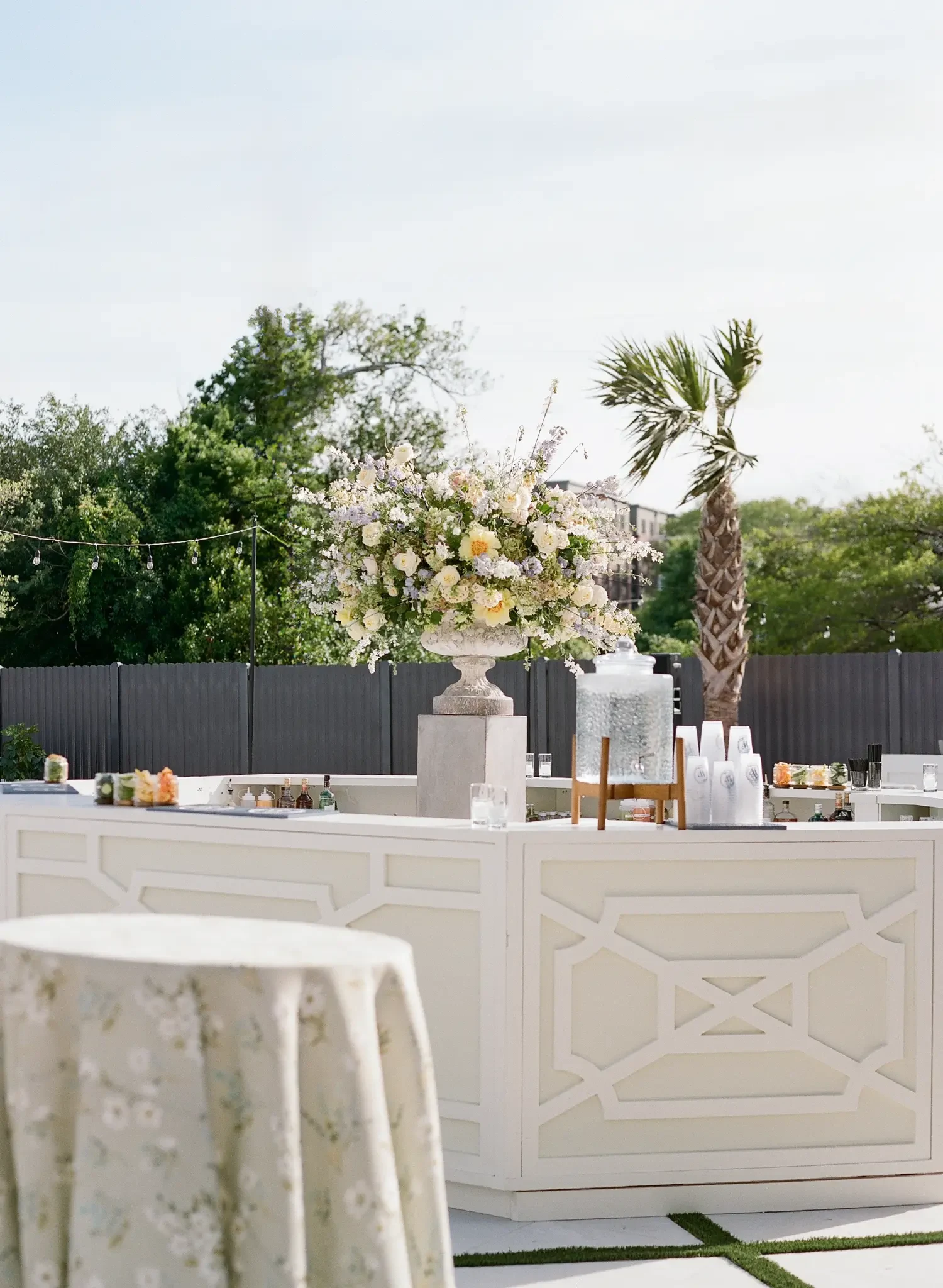 Garden bar at The Waverly with a floral arrangement and beverage dispenser