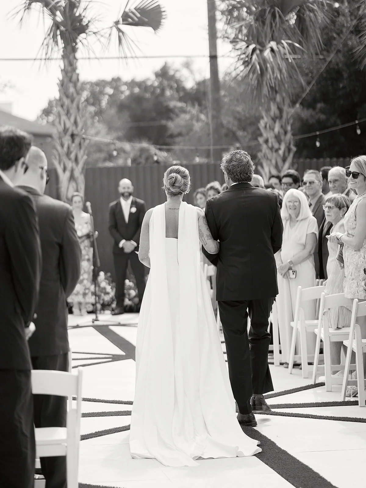 Wedding couple standing together in The Waverly Garden with their guests