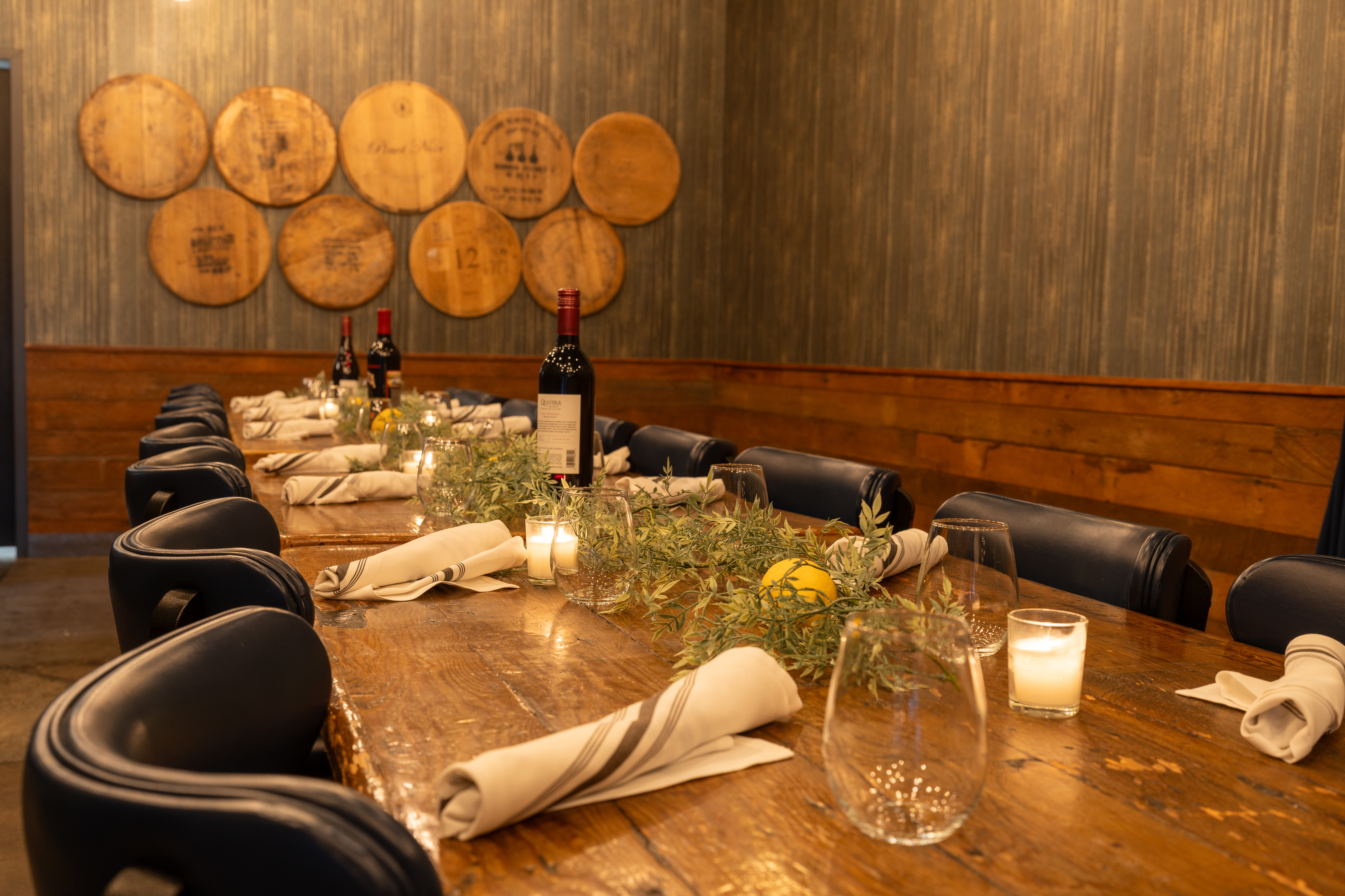 a glass of wine sitting on top of a wooden table