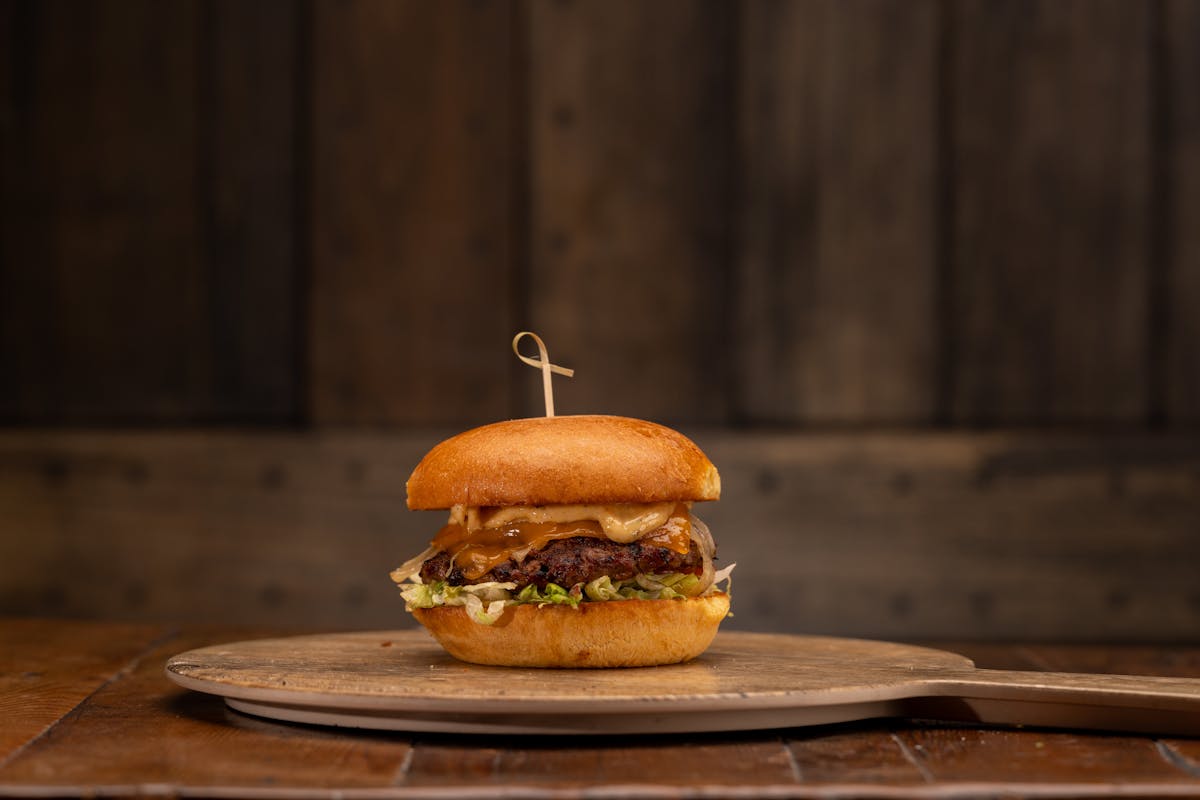 a sandwich sitting on top of a wooden cutting board